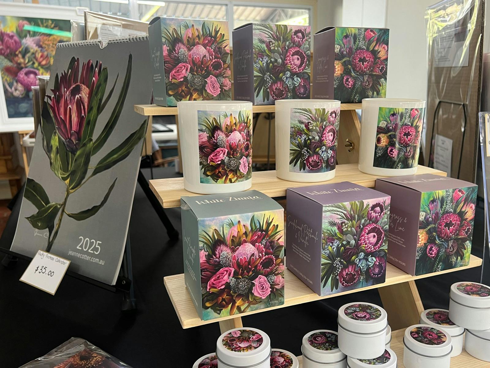 Candles and calendars with original artwork in a studio