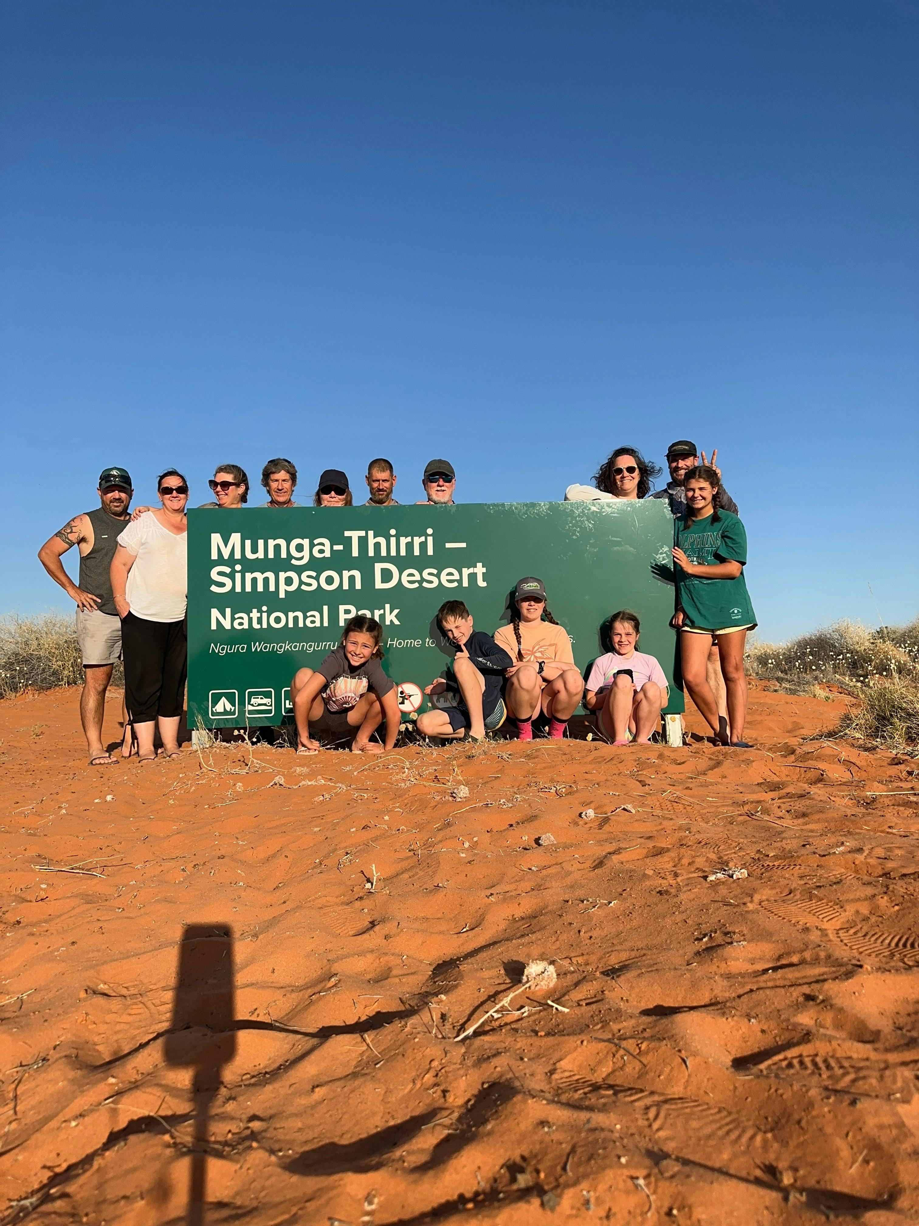 Tour Group at the Munga-Thirri - Simpson Desert NP Sign