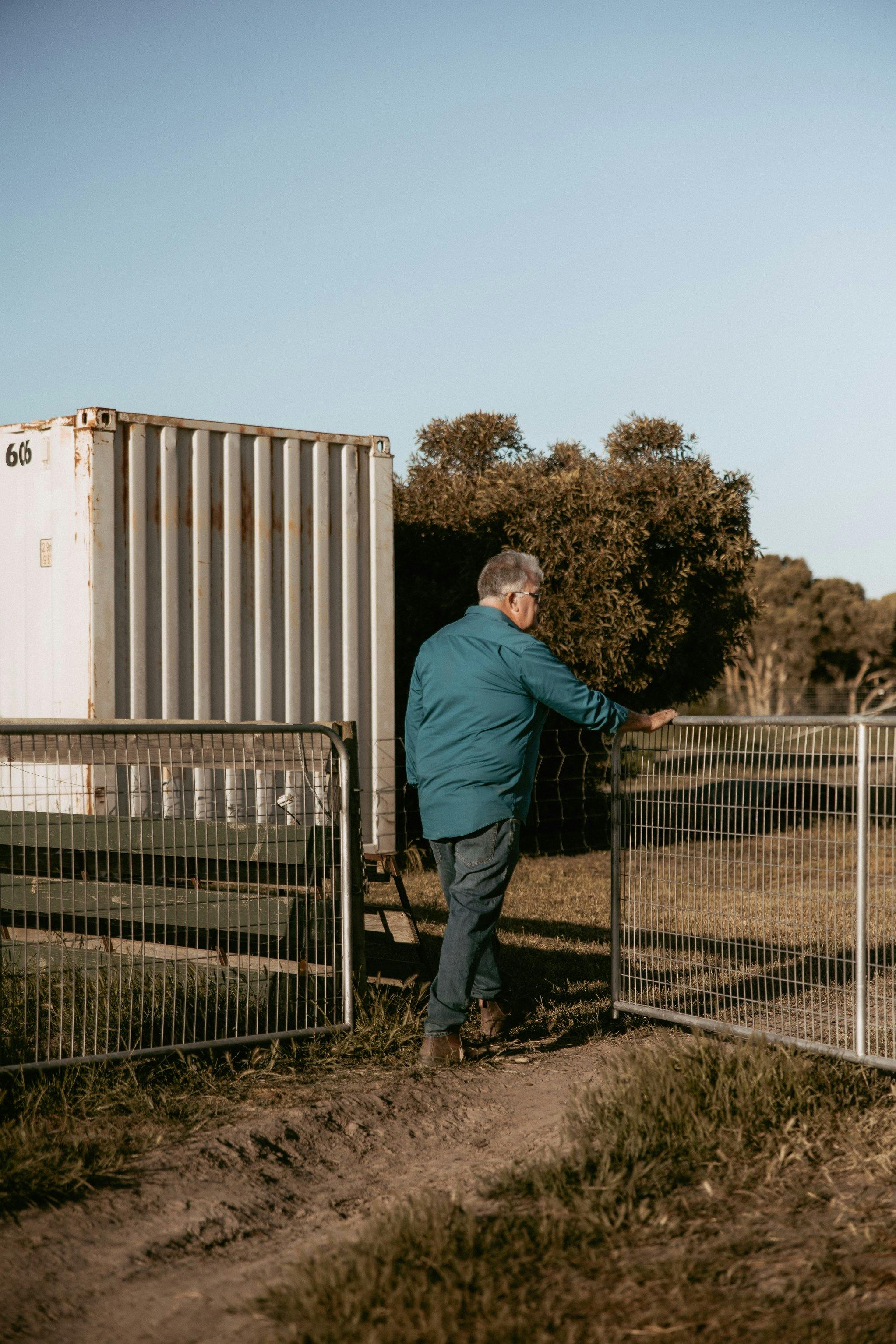 Geoff walking through the gate into the paddock to feed the fold