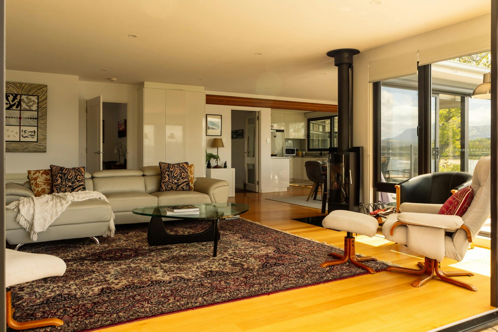 Cosy living room with wood fire at Snug on the Bay showing the couches and coffee table