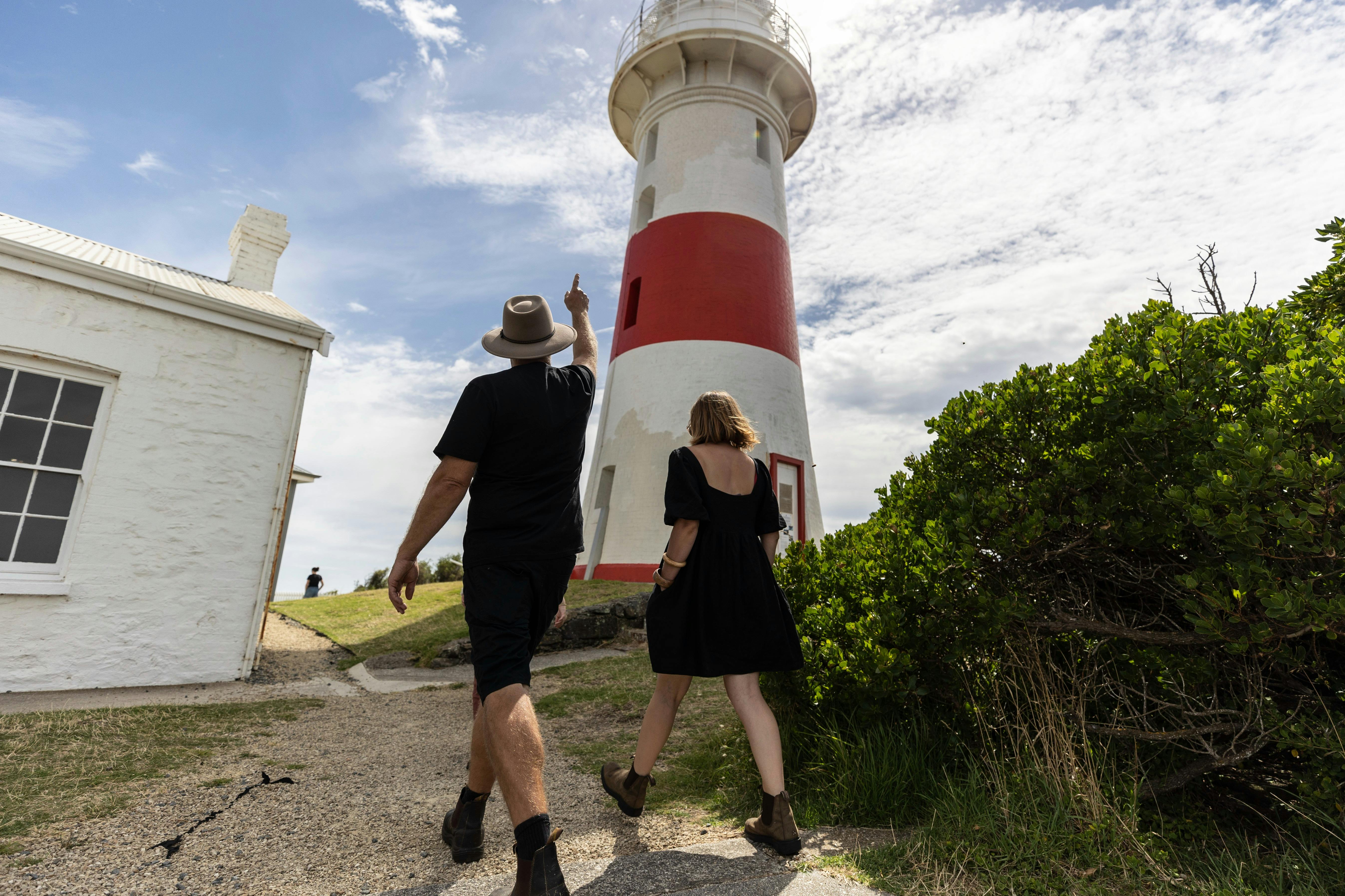 Couple walking toward lighthouse