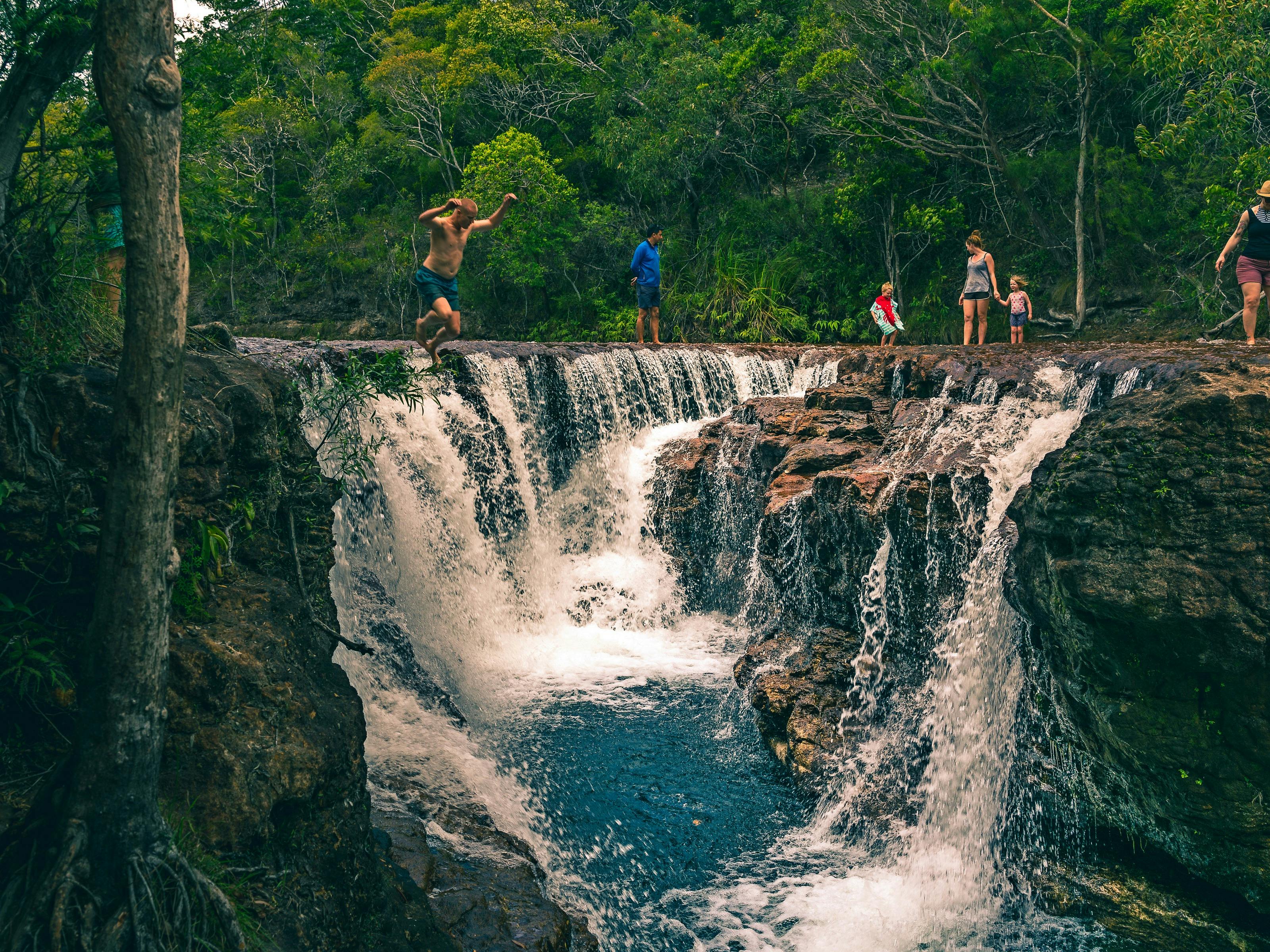 Group of people swimming and jumping at Eliot Falls (not Elliot falls!) in Jardine National Park.