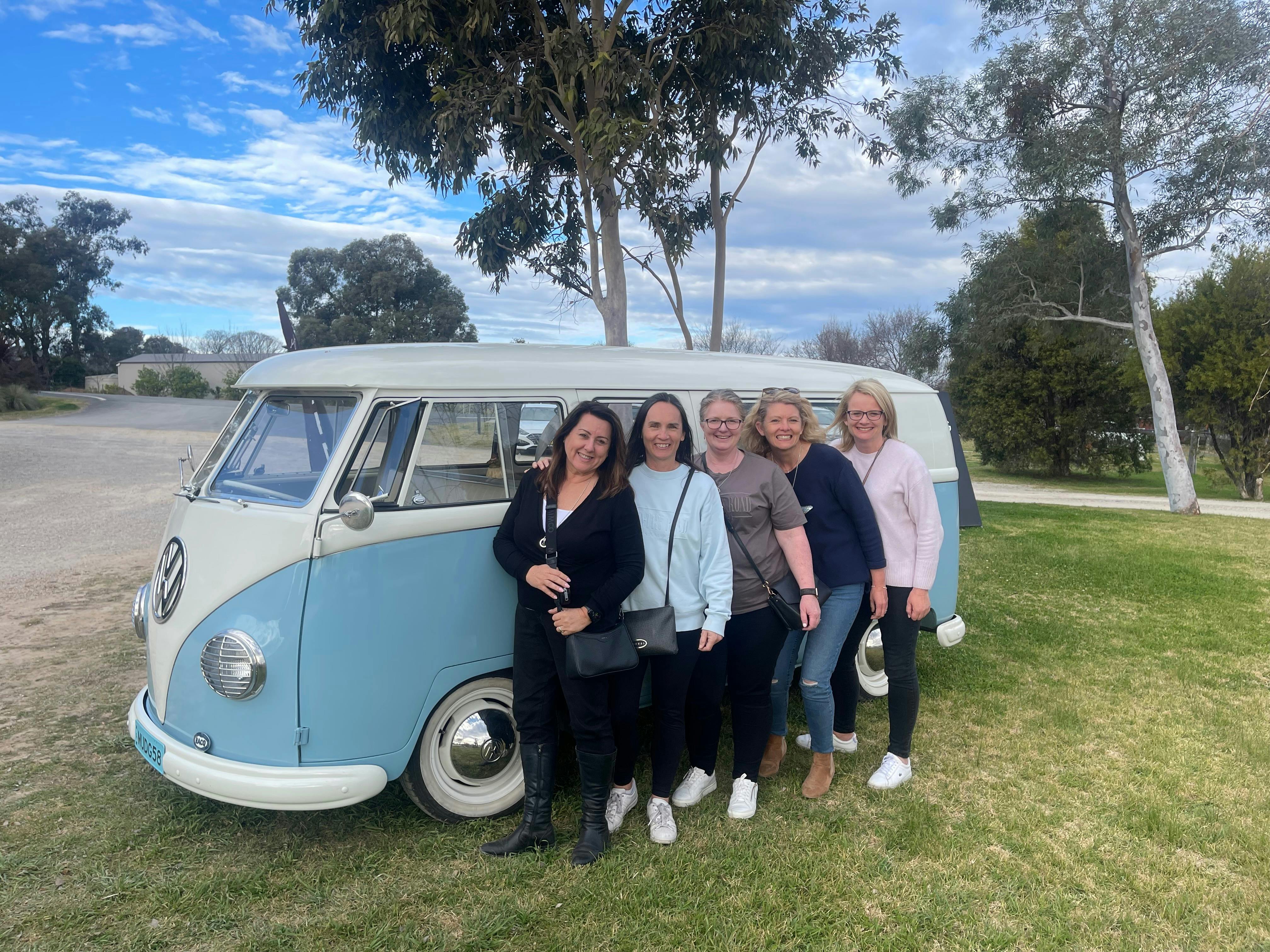 Ladies beside blue Kombi