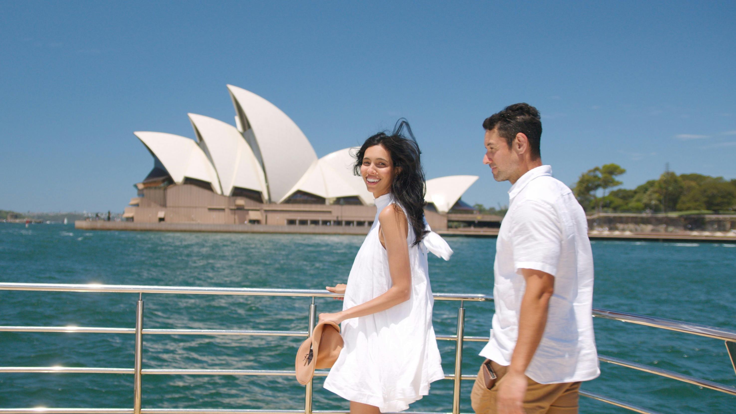 couple enjoy sightseeing cruise near Sydney Opera House