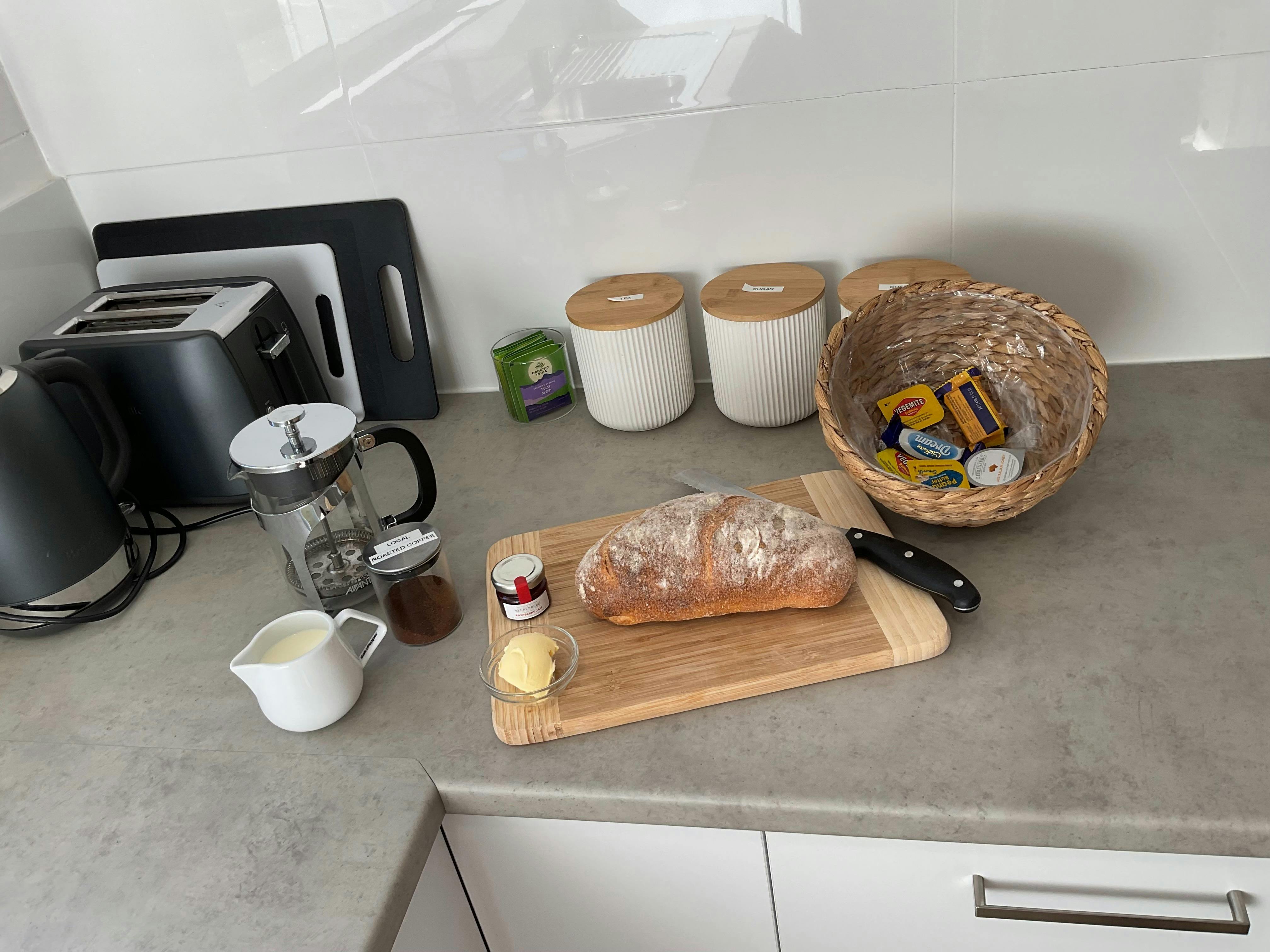 In room continental breakfast on the kitchen bench, with fresh bread, tea and coffee.