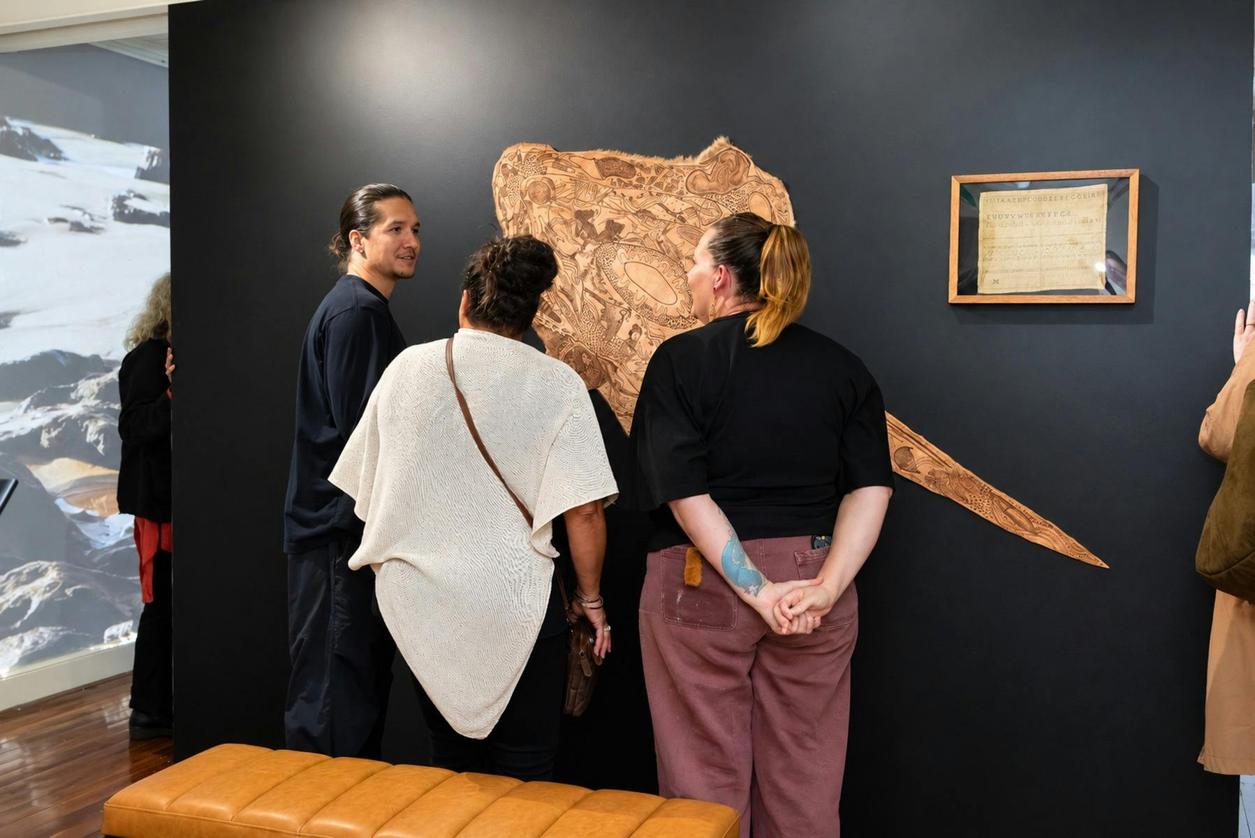 Visitors viewing kangaroo skin artwork