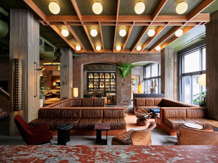 interior of the Ace Hotel Sydney showing the Lobby and Bar area with leather banquette seating  and