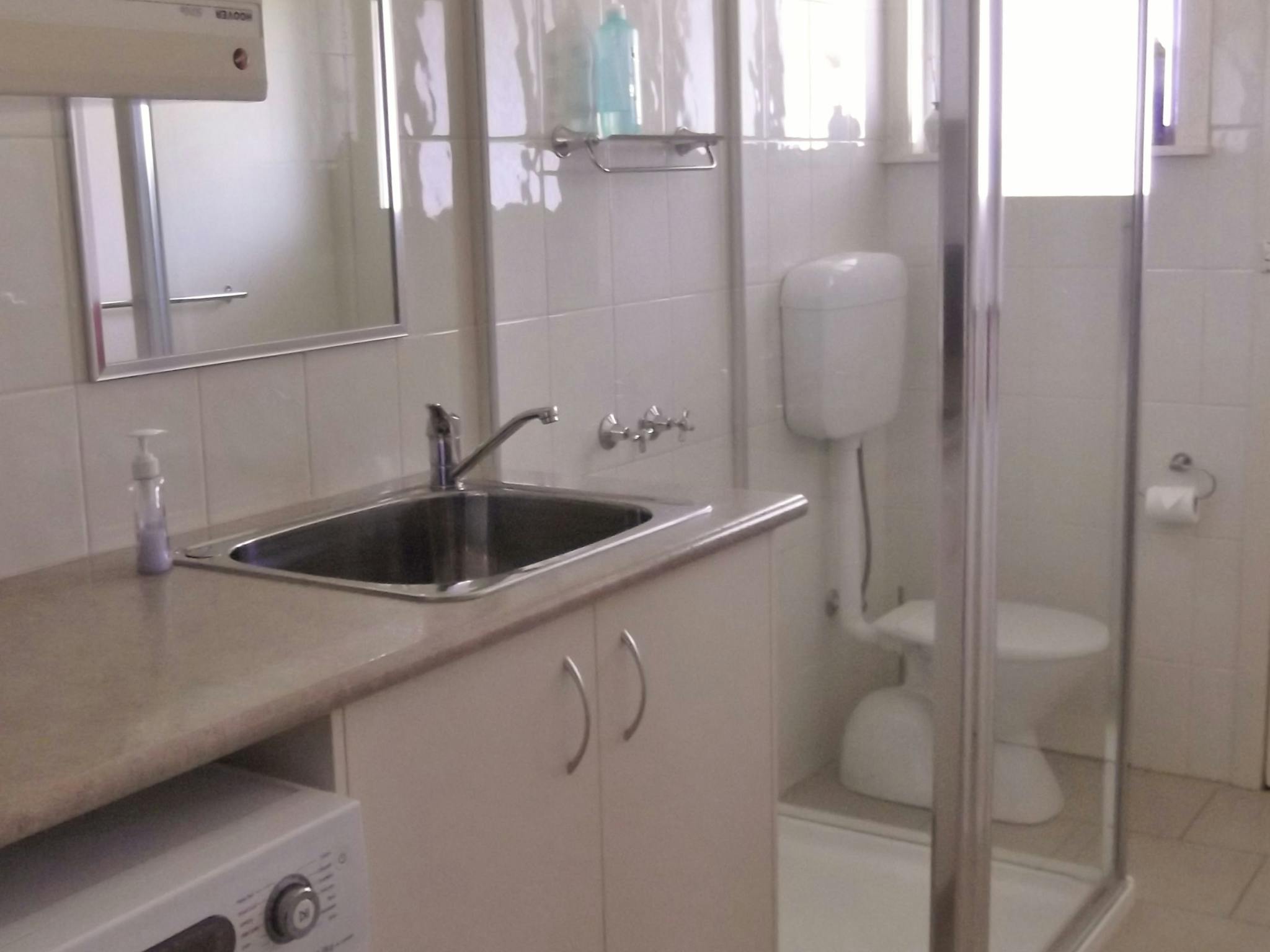 2nd bathroom/laundry with shower, toilet and laundry trough with washing machine and dryer