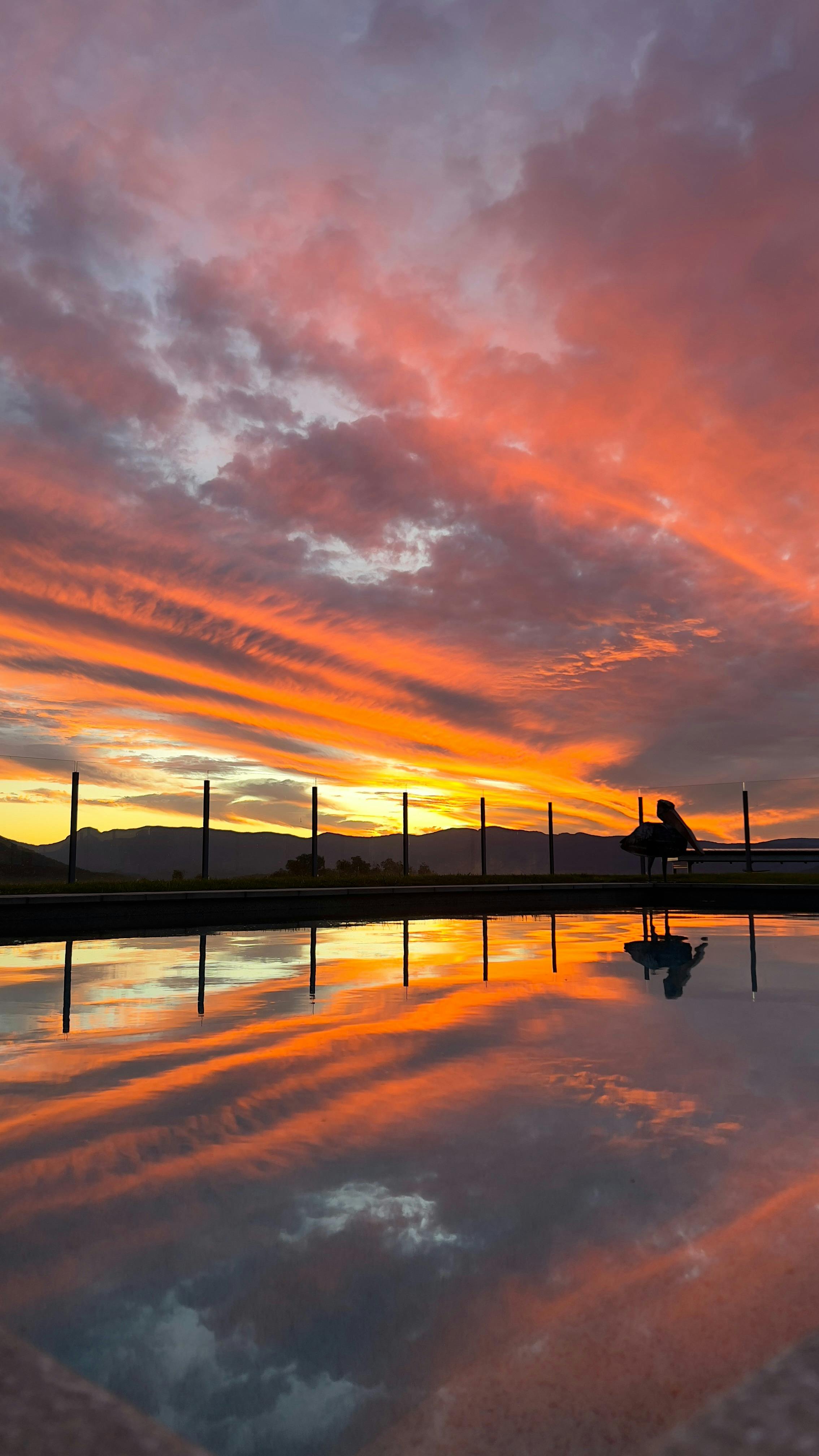 As the sun sets over the mountains, the pool at Mount French Lodge transforms into a tranquil oasis