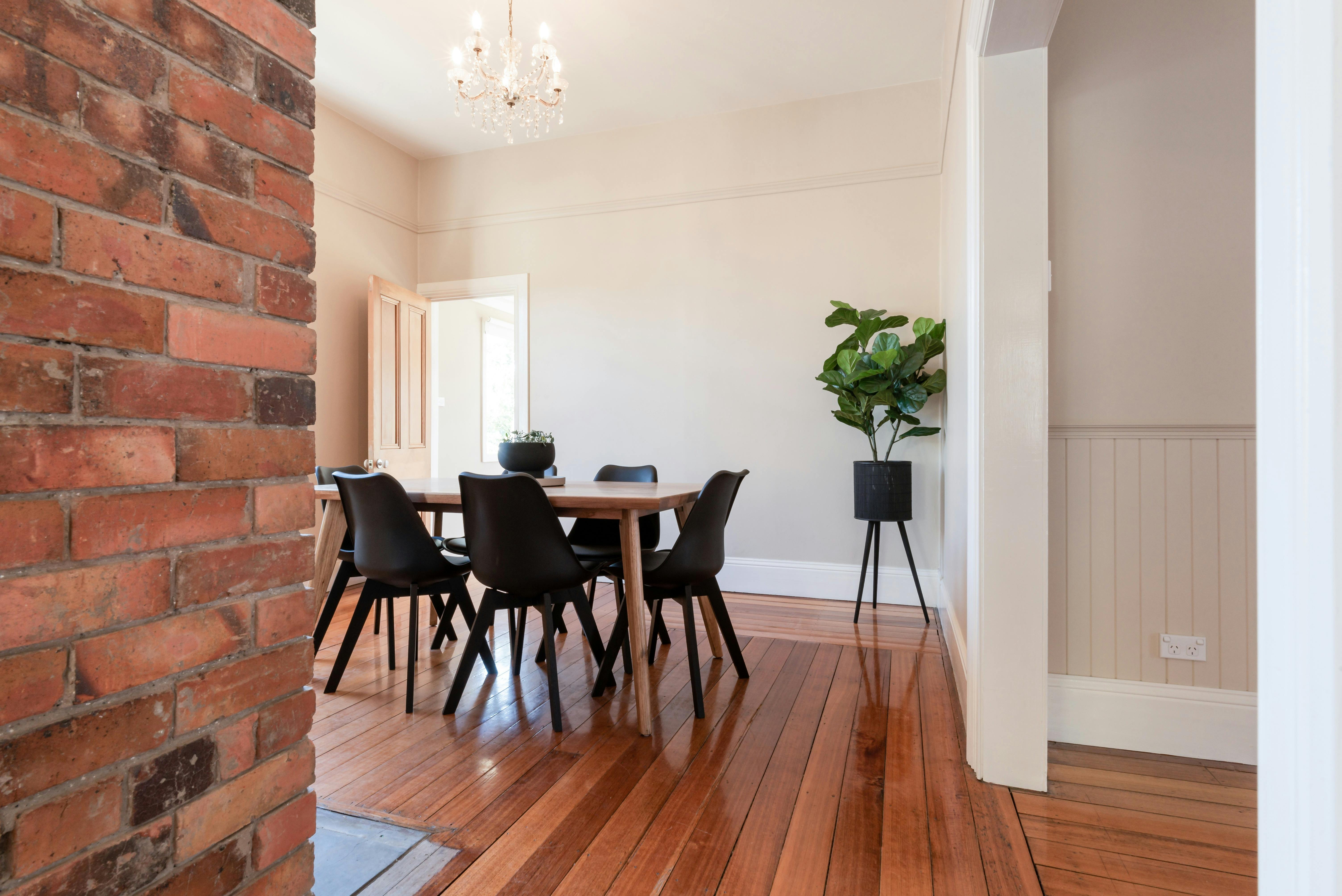 Dining area with heritage brick feature at Gorgeous on Galvin holiday home