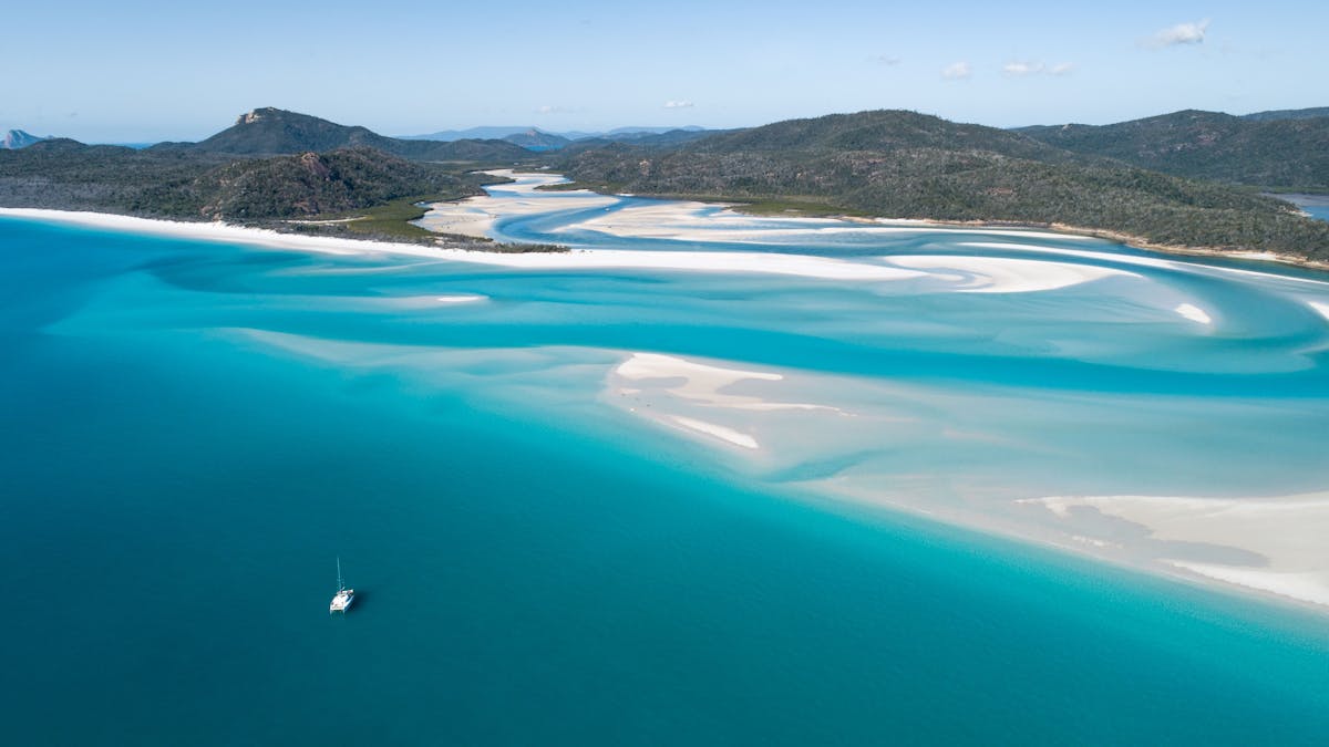 Spectacular white sandy beaches all yours to explore sailing the Whitsundays on a  Bareboat Charter