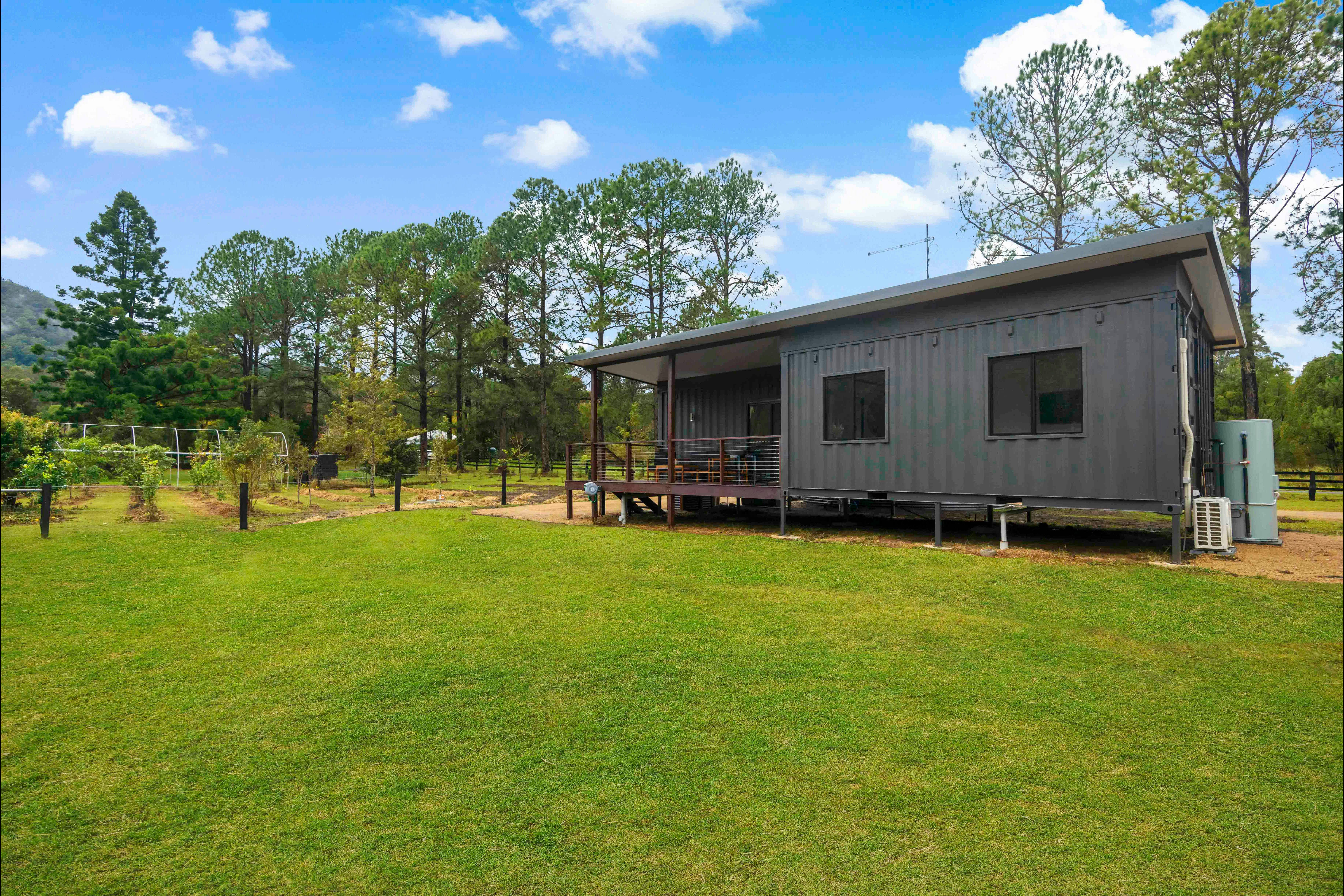 External shot of cottage showing its position in relation to the permaculture orchard.