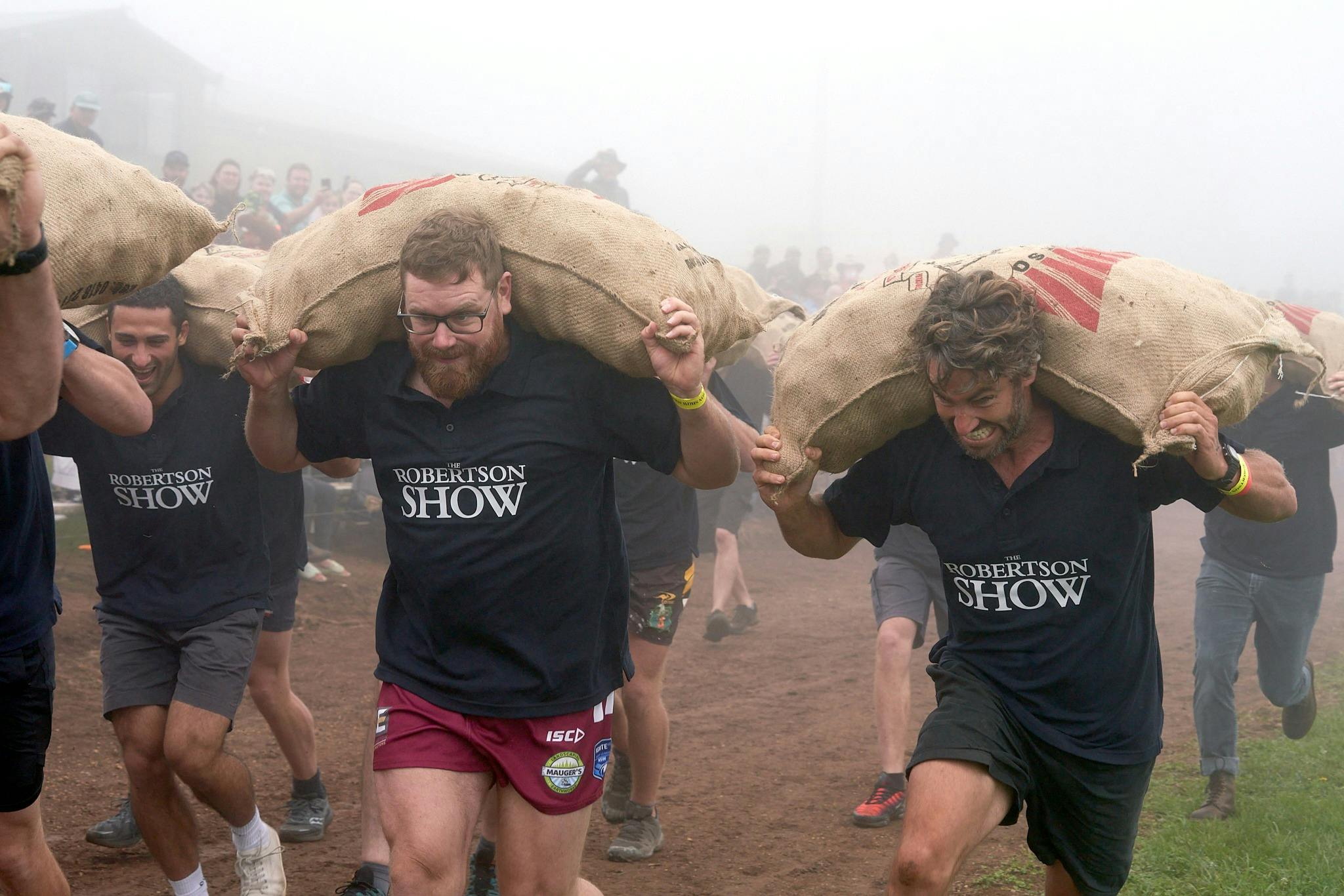 Open Potato Race - 3 competitors running with Potato sacks