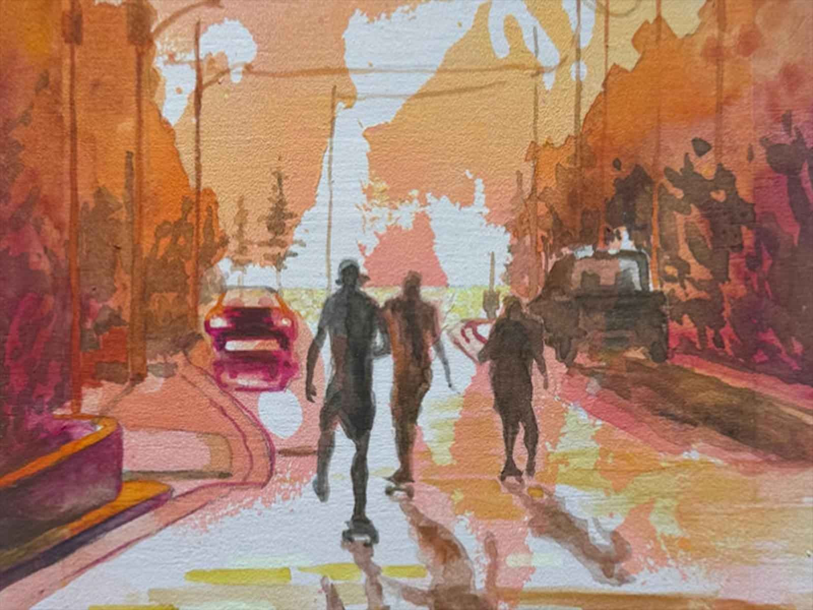 People walking down a street at sunset