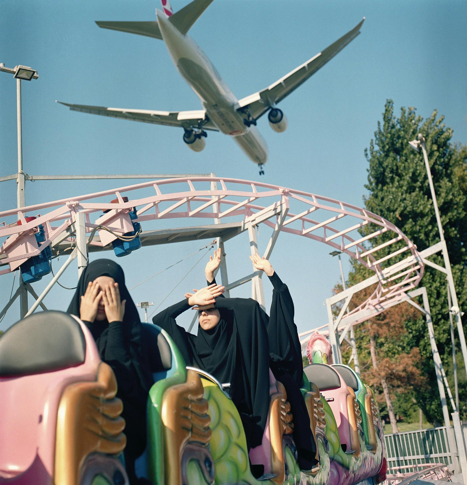 Sabiha Çimen A plane flies low over students at an amusement park. Istanbul, 2018.
