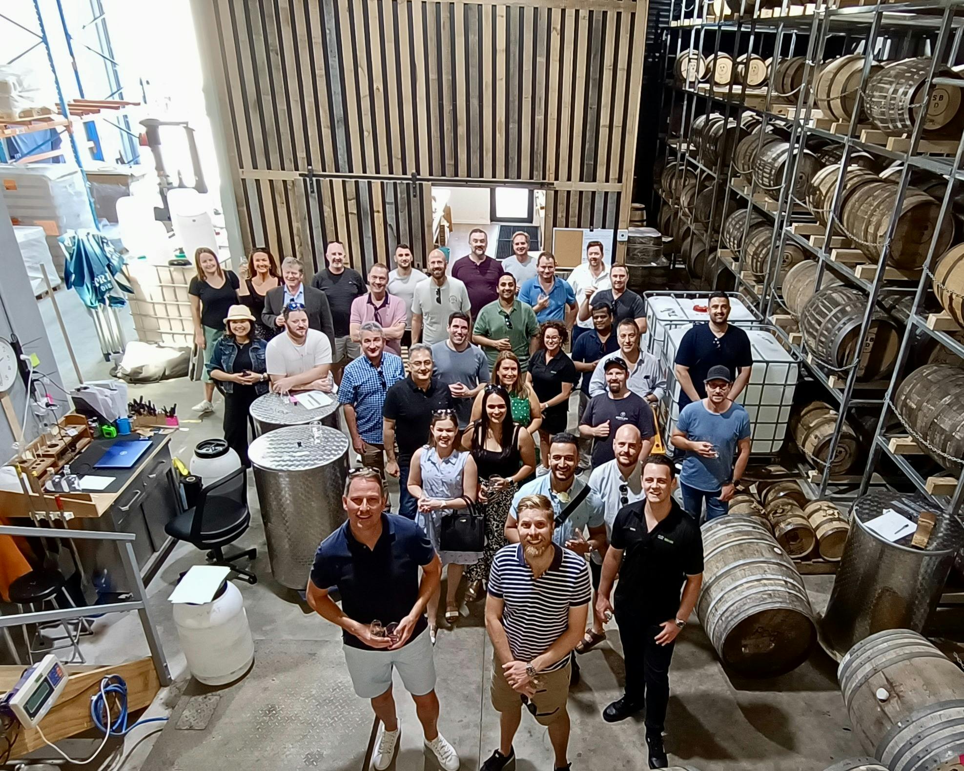From above - a large group on tour in a whisky bond store