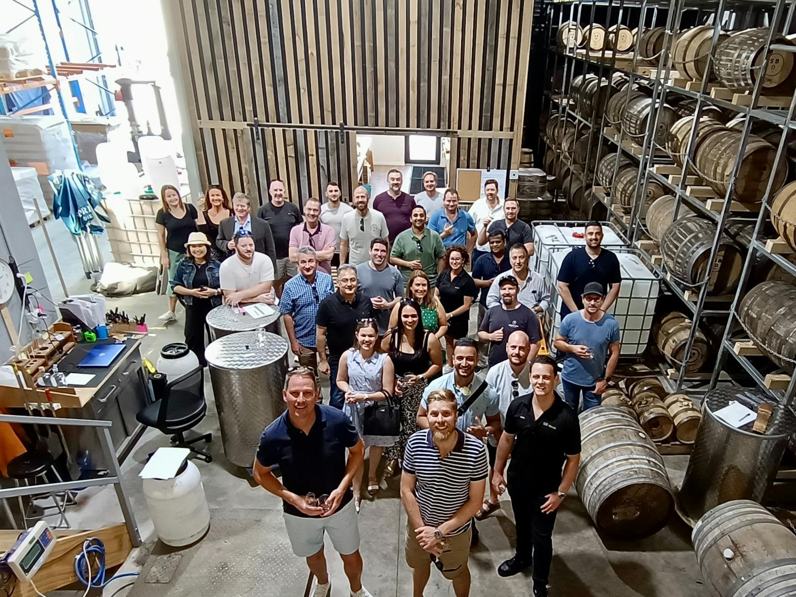 From above - a large group on tour in a whisky bond store