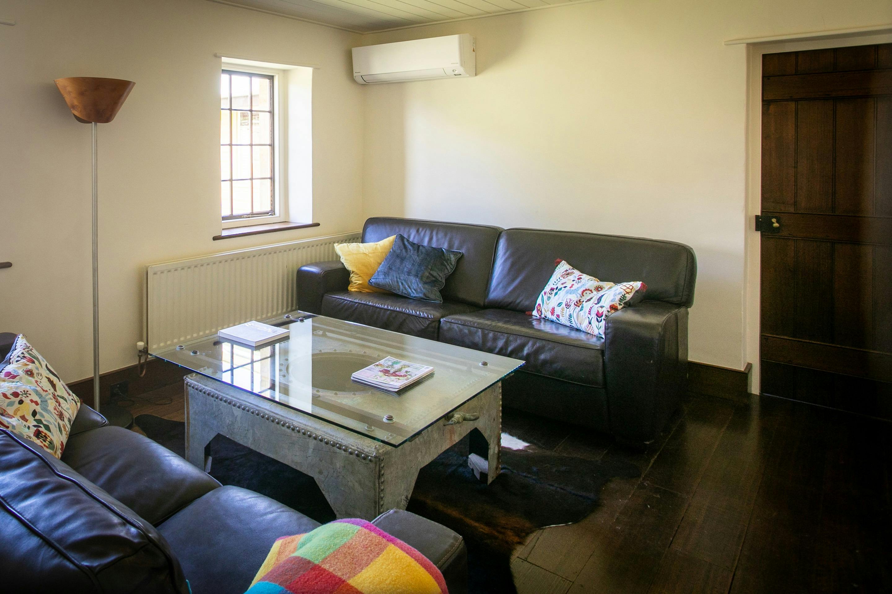 2 leather lounges in lounge room, big screen TV