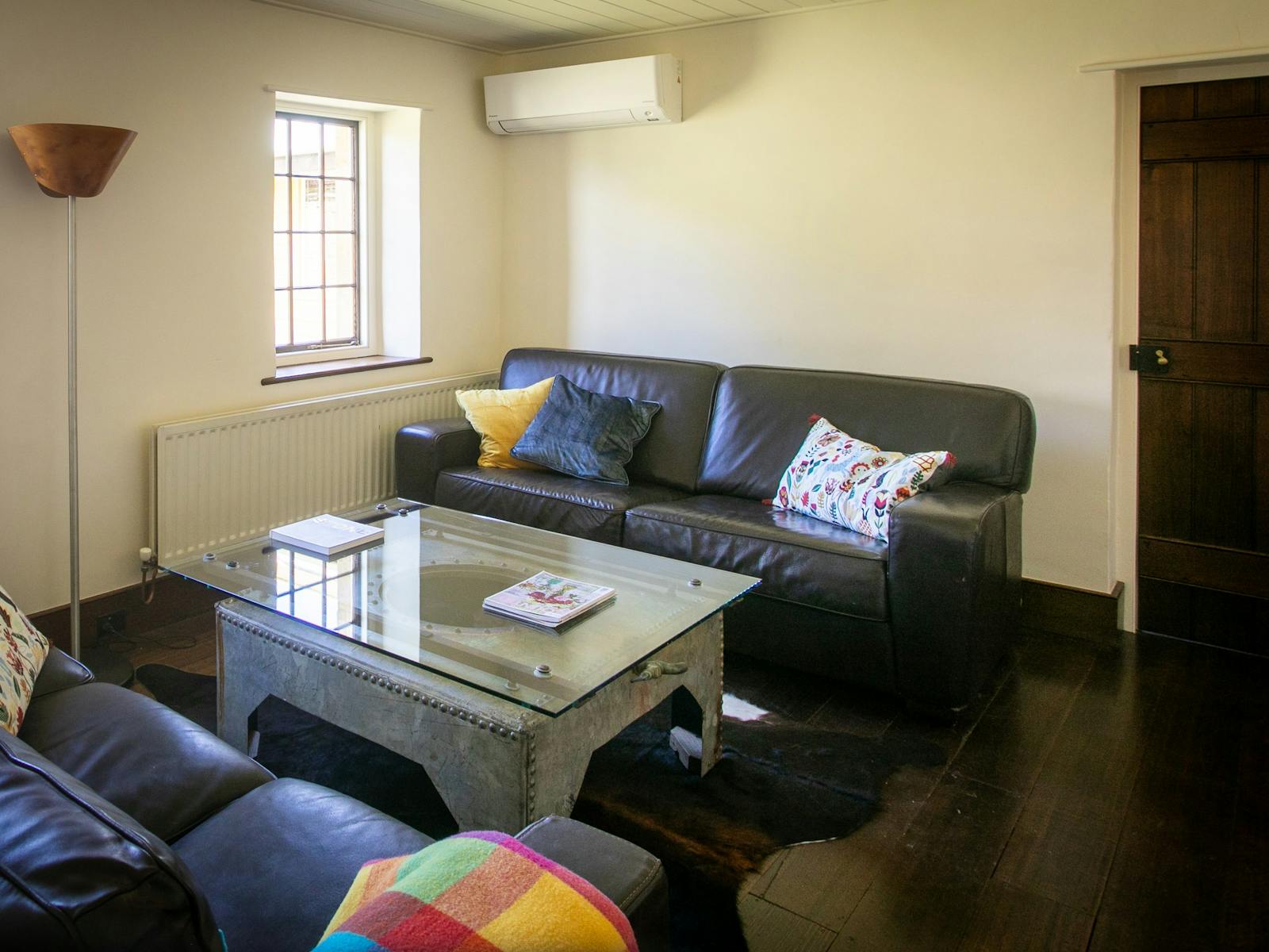 2 leather lounges in lounge room, big screen TV