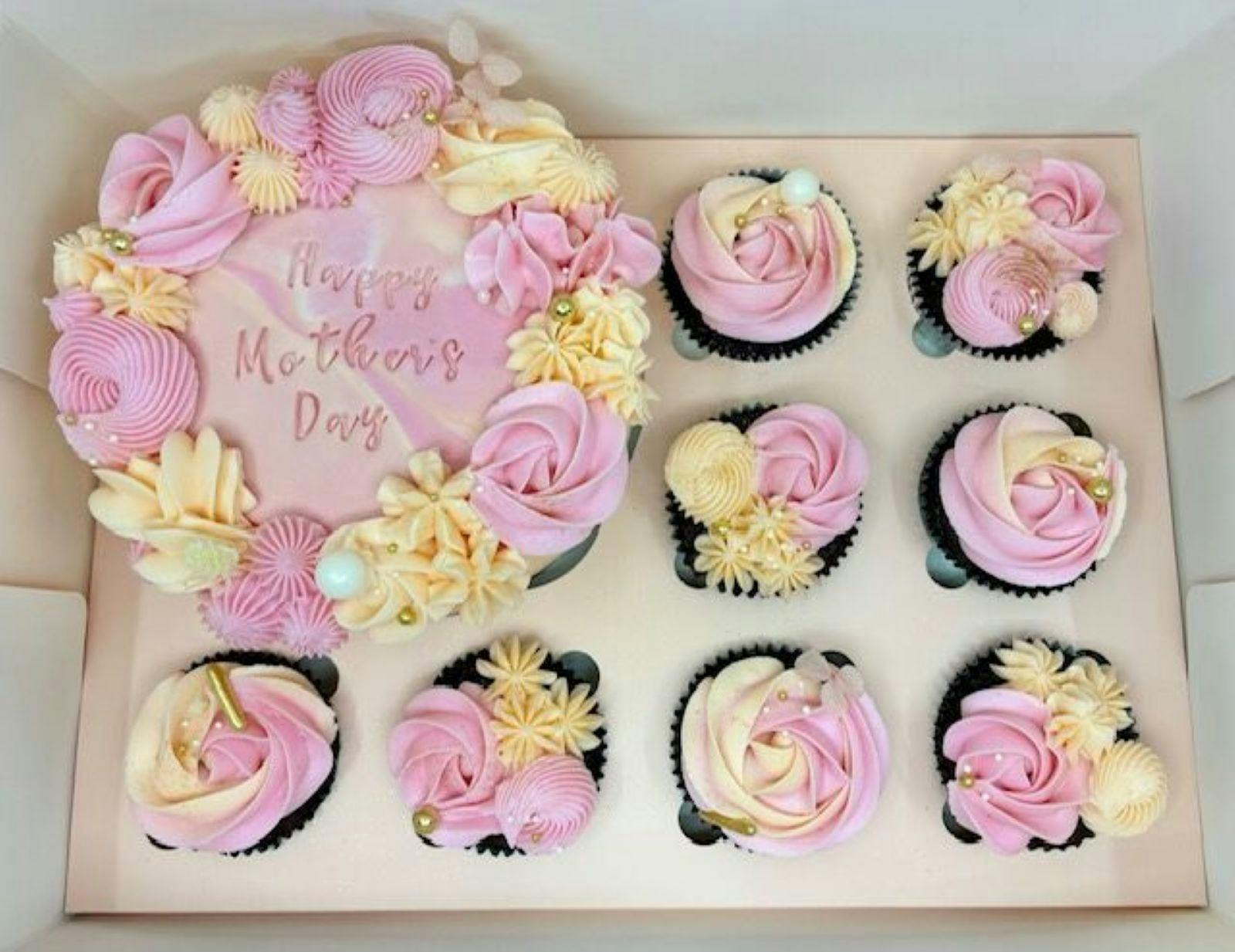 A 5 inch cake and 8 cupcakes with peach and pink piping.