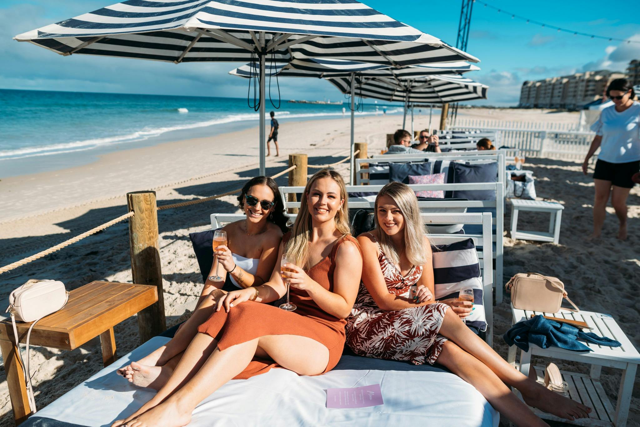 Group of girls on a daybed at Moseley Beach Club