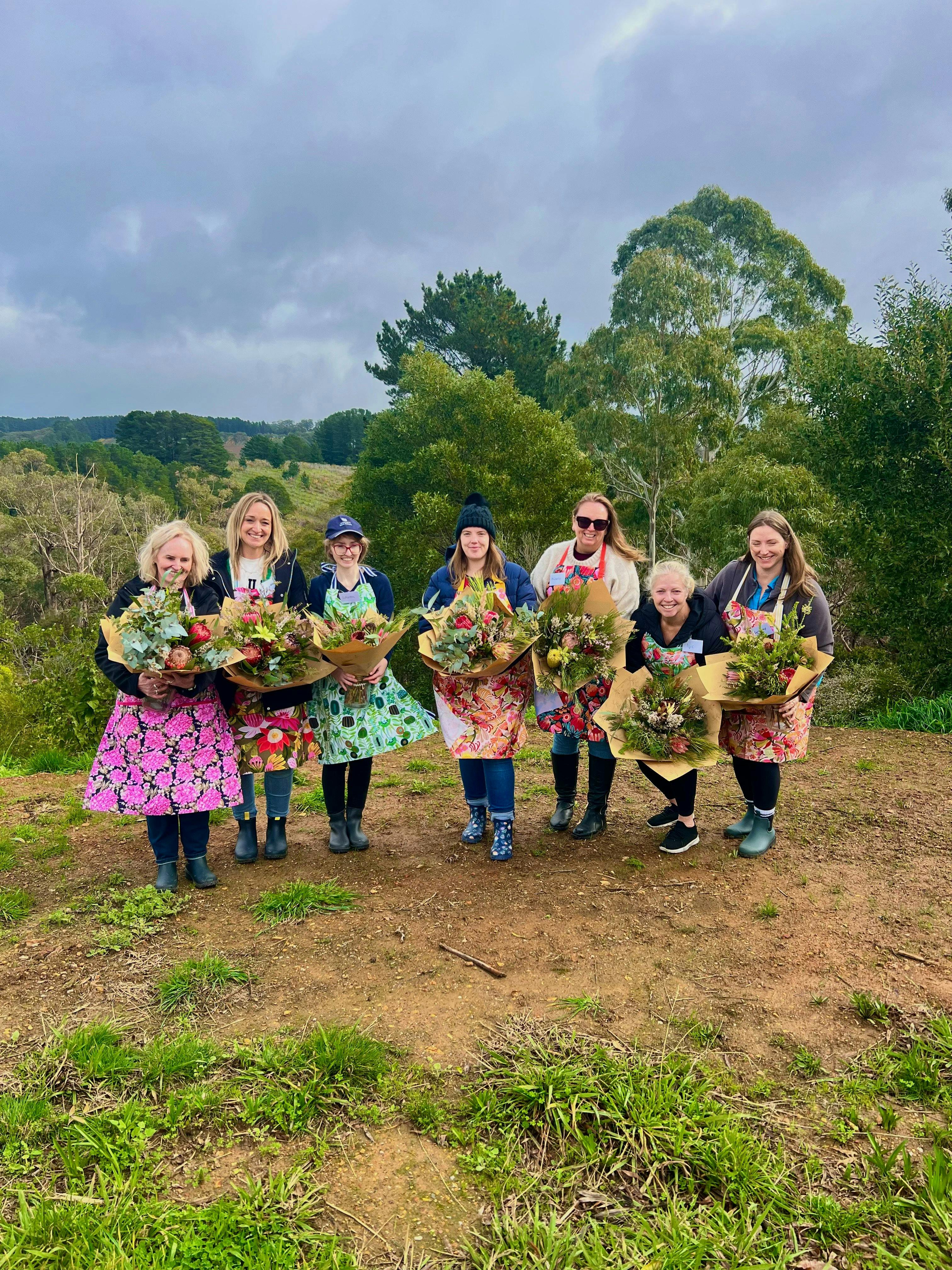 Workshop participants showcasing their unique bouquet creations