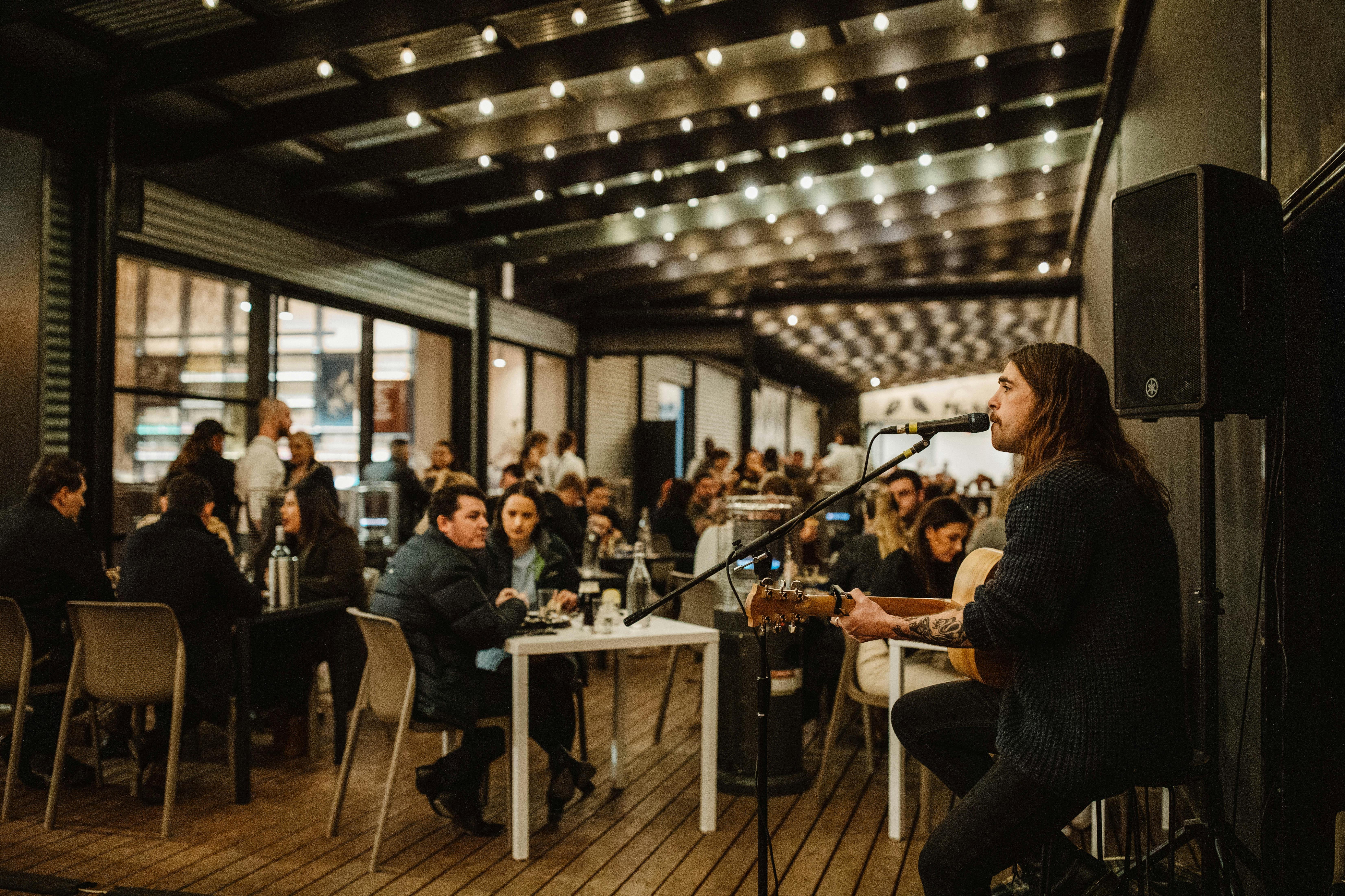 Evenings at Never Never Distilling Co. with live music and soft lighting.