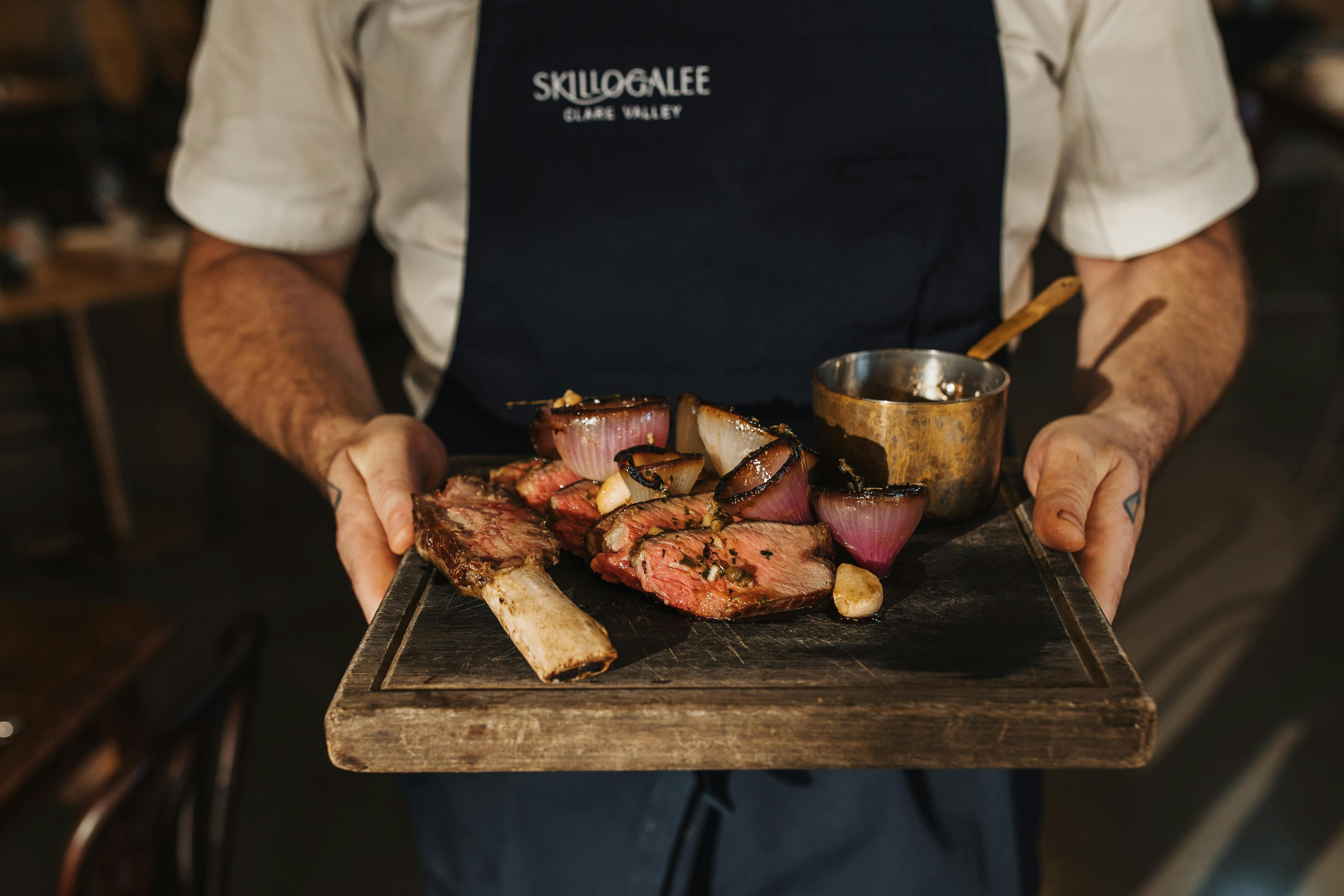 An image of a dish of heritage beef, charred onions and Bordelaise Sauce