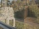 Reflection of nature on outside of sauna glass looking into sauna heater and cedar bench