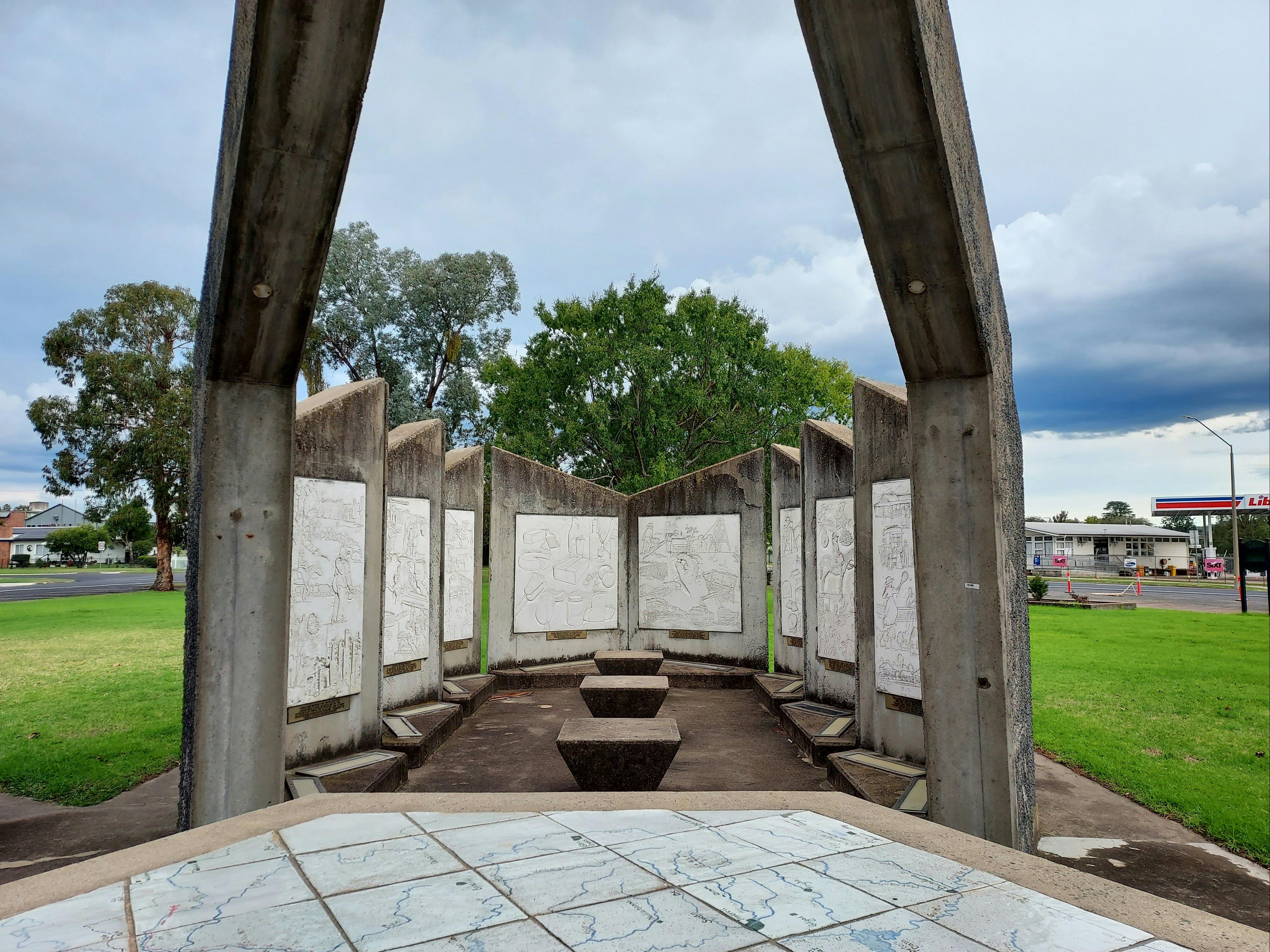 Interior of courthouse 3 with 8 sculptured bas-relief panels on walls & 3 concrete seats in middle