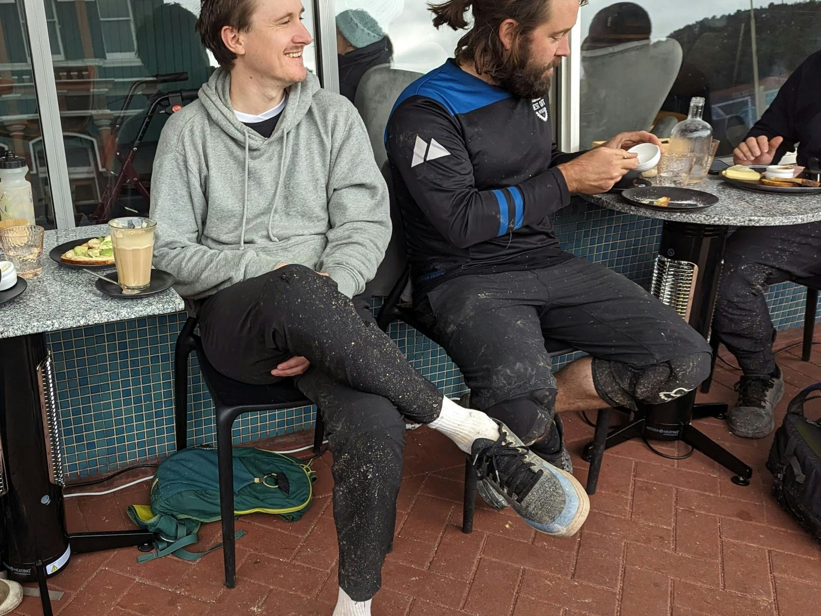 2 people sitting outside the front of Moonscape wine bar enjoying coffees and snacks