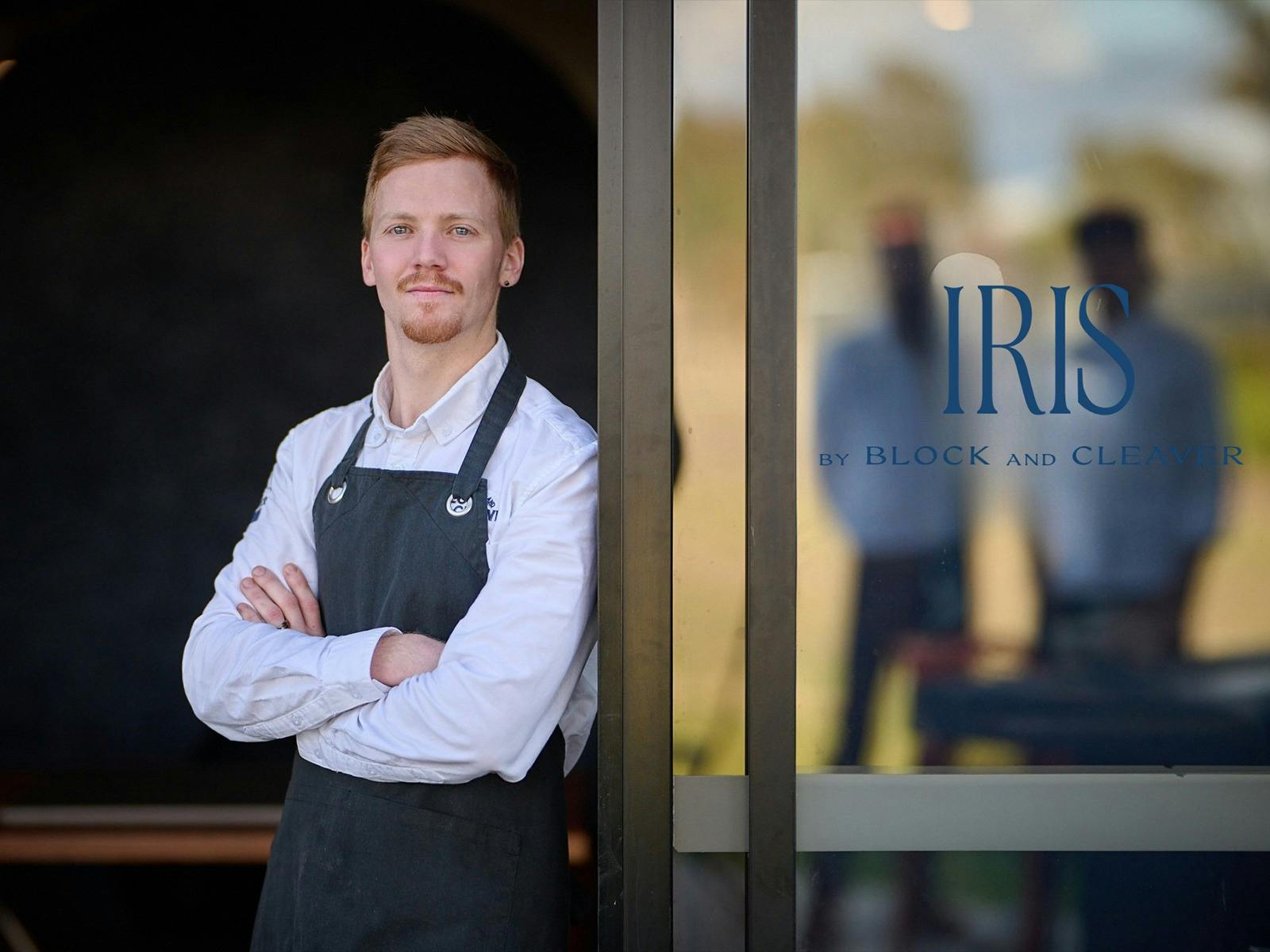 Executive Chef Dean Sibthorp standing next to the doorway at Iris