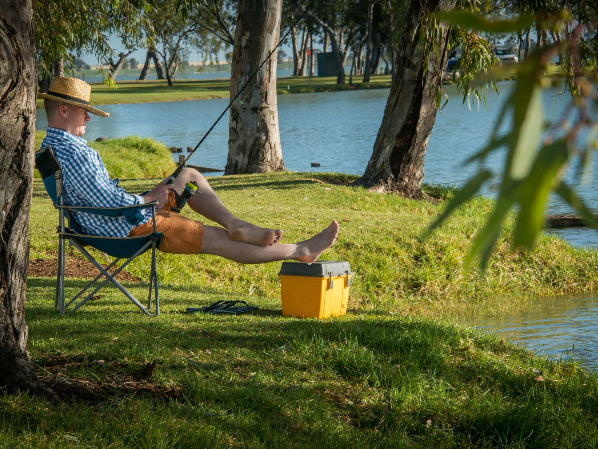A fisherman relaxing while fishing at Lake Charm