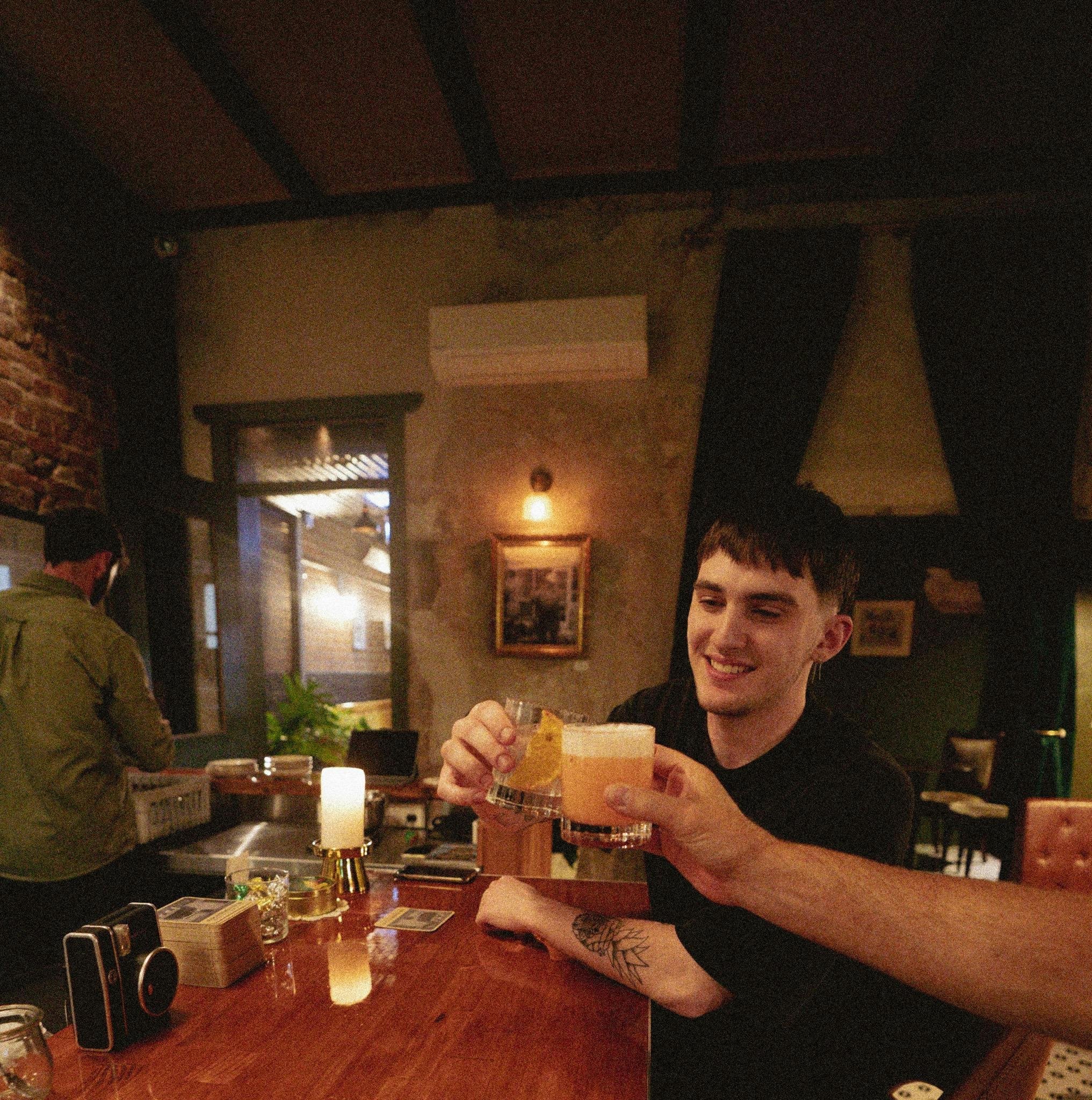 A customer enjoying a drink at the bar of Granddad's Bar Newcastle