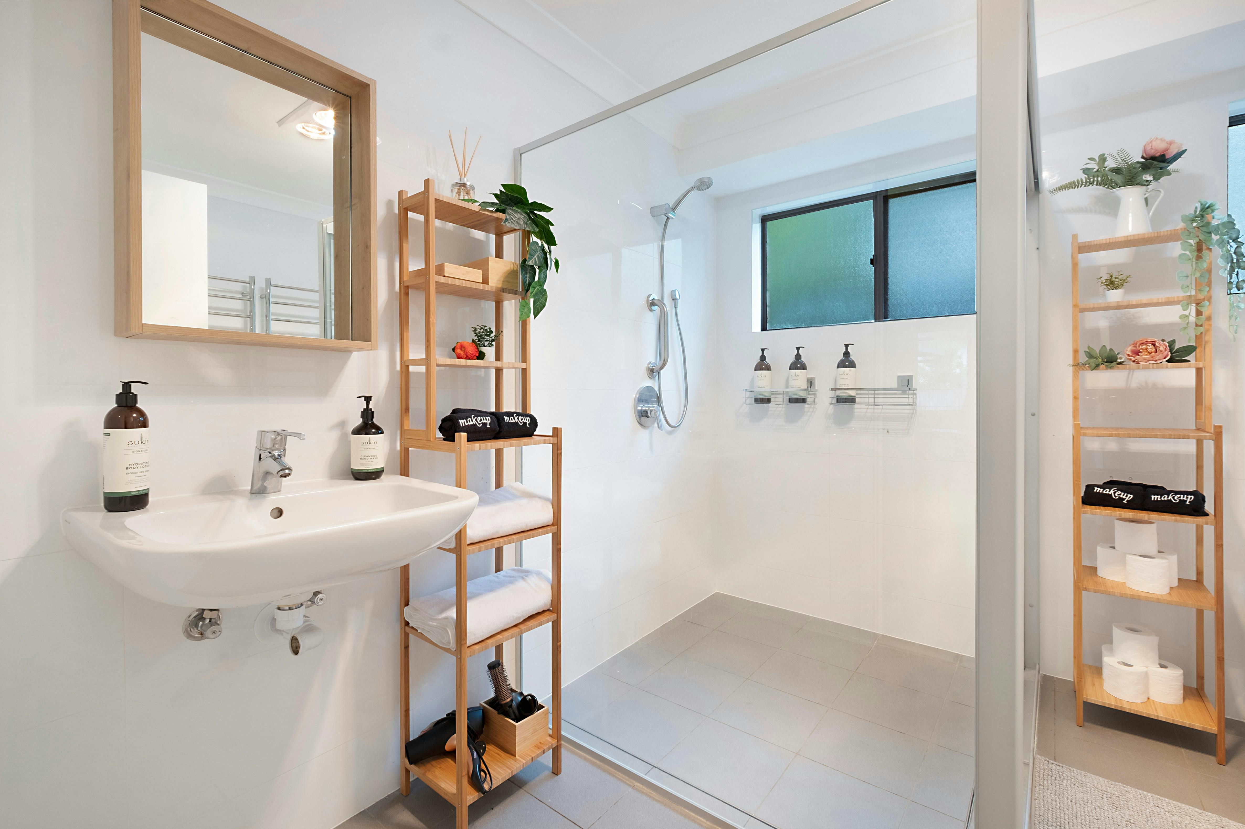 The larger bathroom, shared by those in bedrooms #2-5. Massive shower area including hand rail.