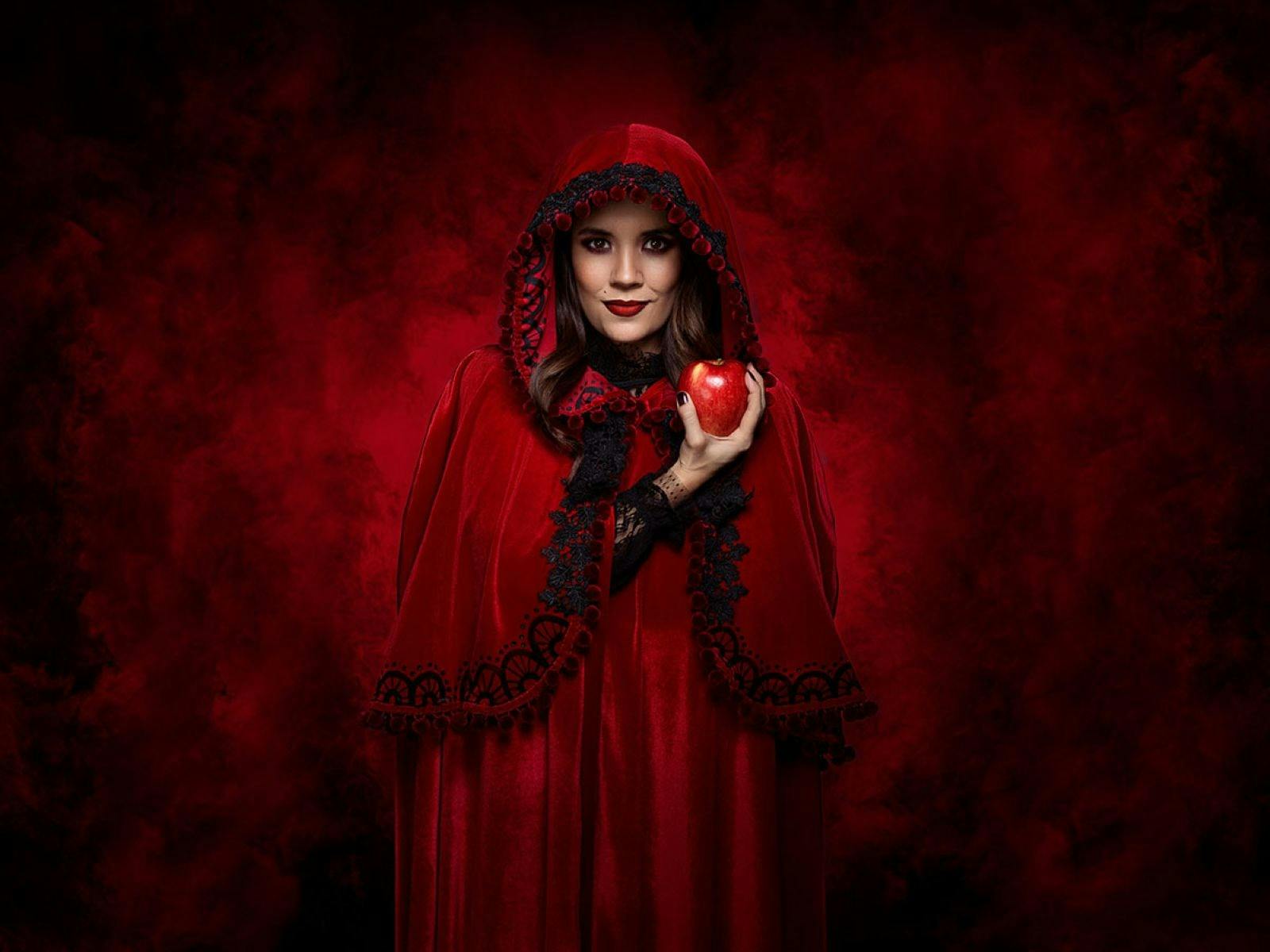 Women in red robe holding an apple