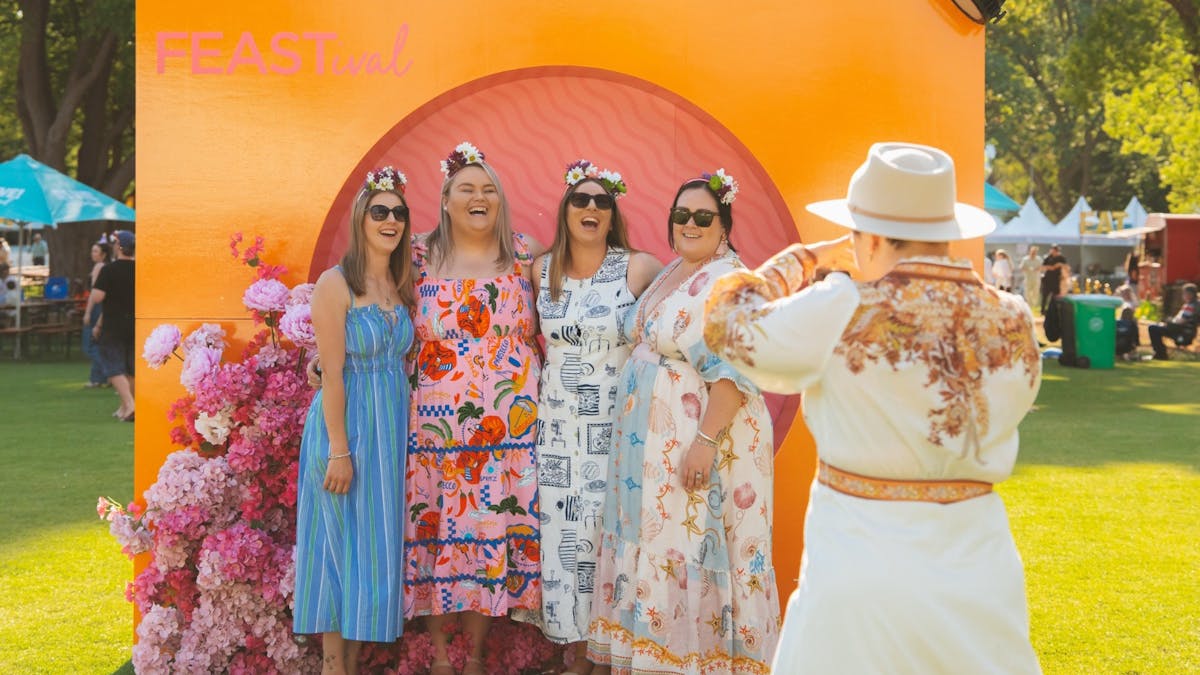A group of women pose for a photo at a food festival
