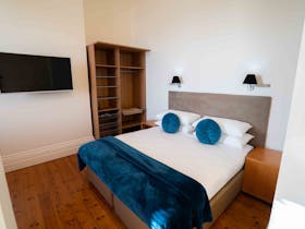 King size bed in Matthews Suite. TV with free to air and streaming services access.