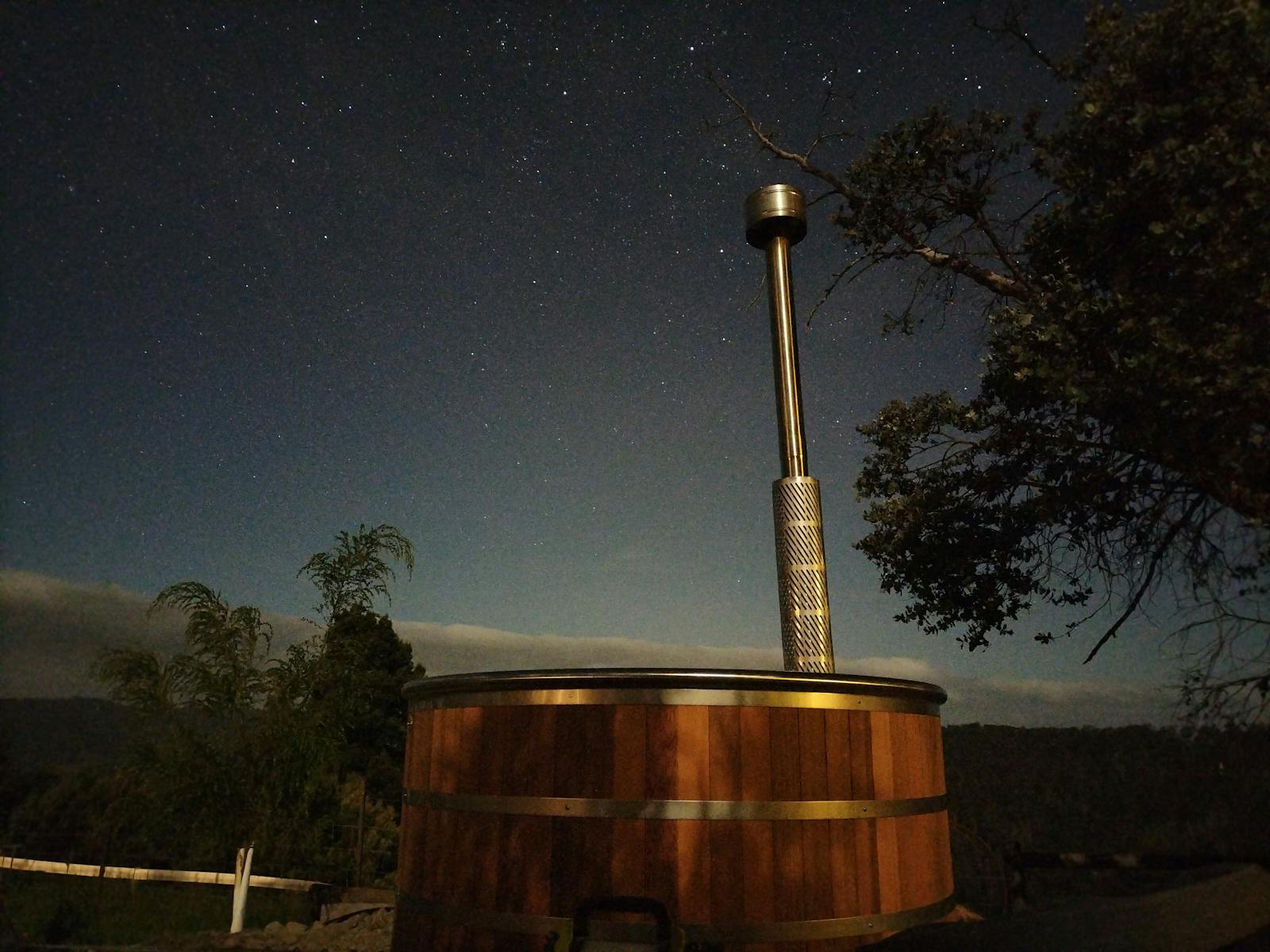 Nighttime view of wood-fired hot tub with stars