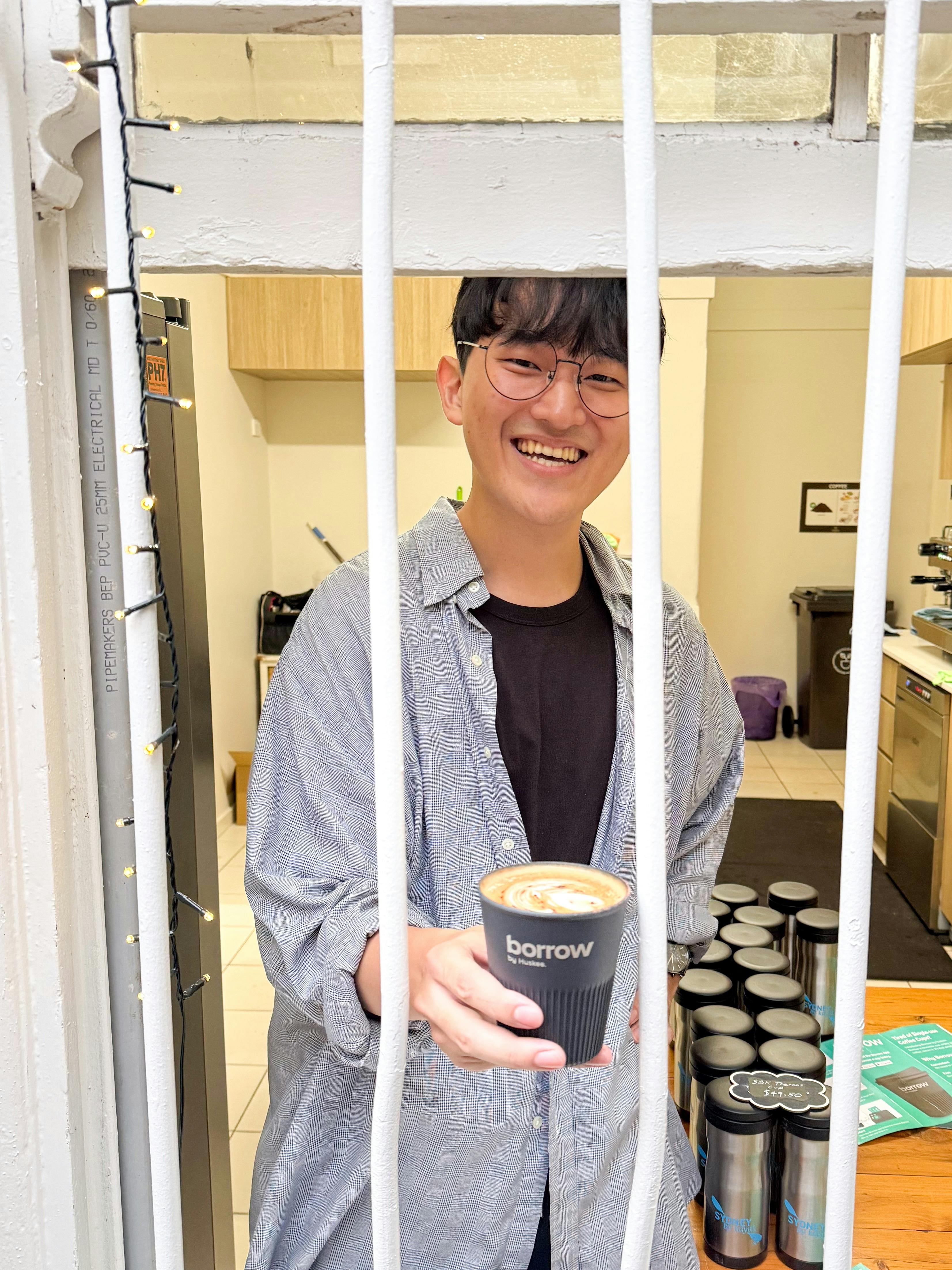 Dawn our barista serving a premium coffee from huskee borrow cups out of the blues point speakeasy