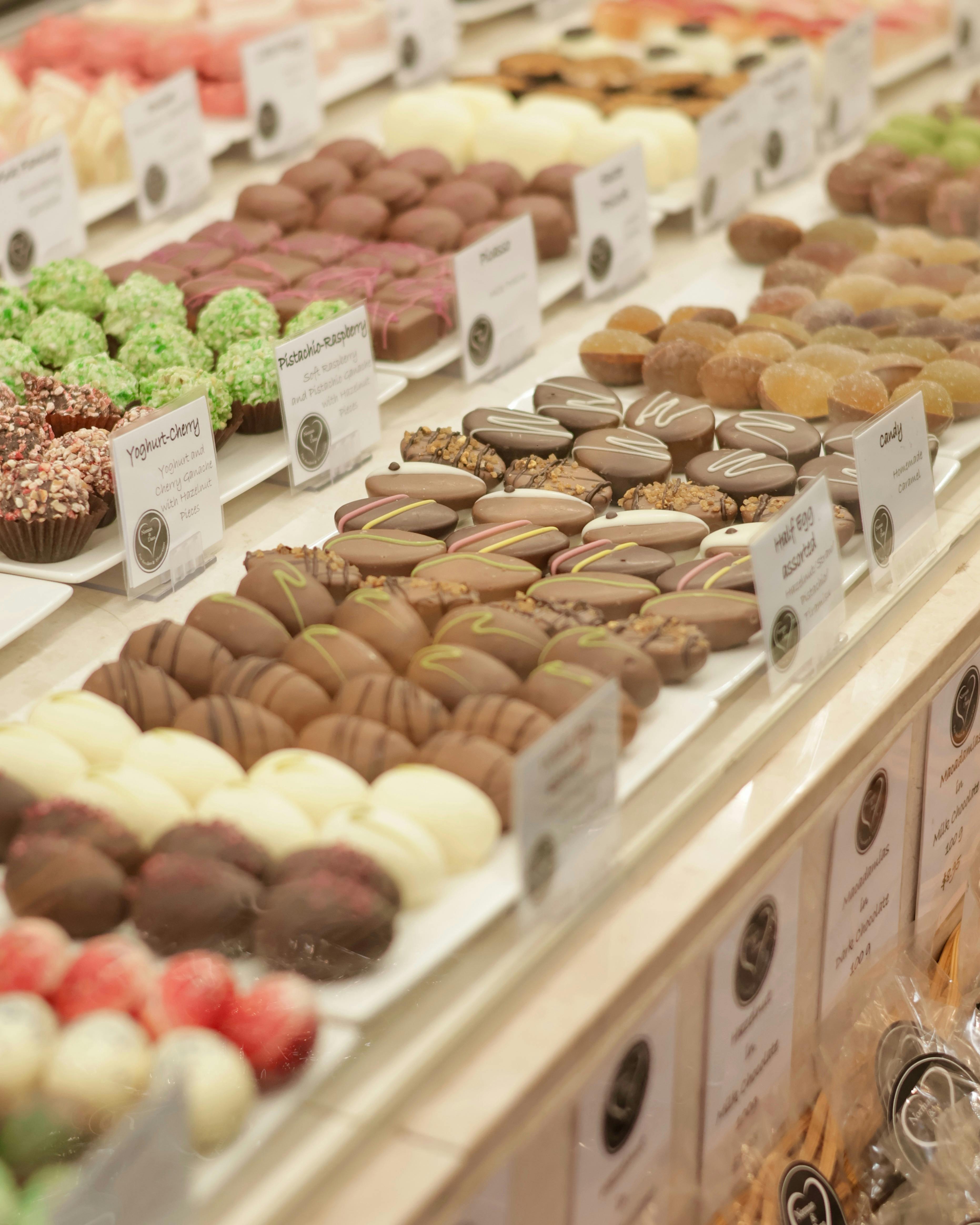 Large array of assorted chocolates to buy from counter.