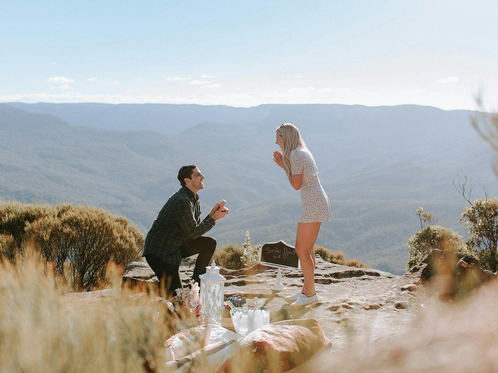 A person kneeling on a rock with a person kneeling