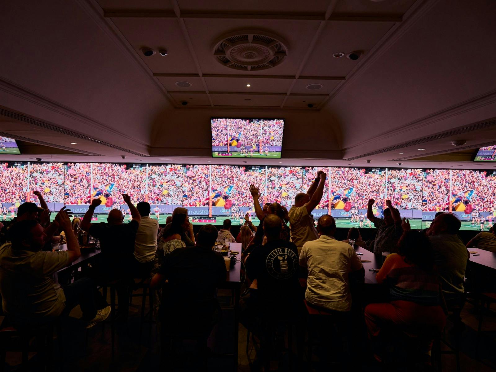 fans watching footy grand final at the district sports bar