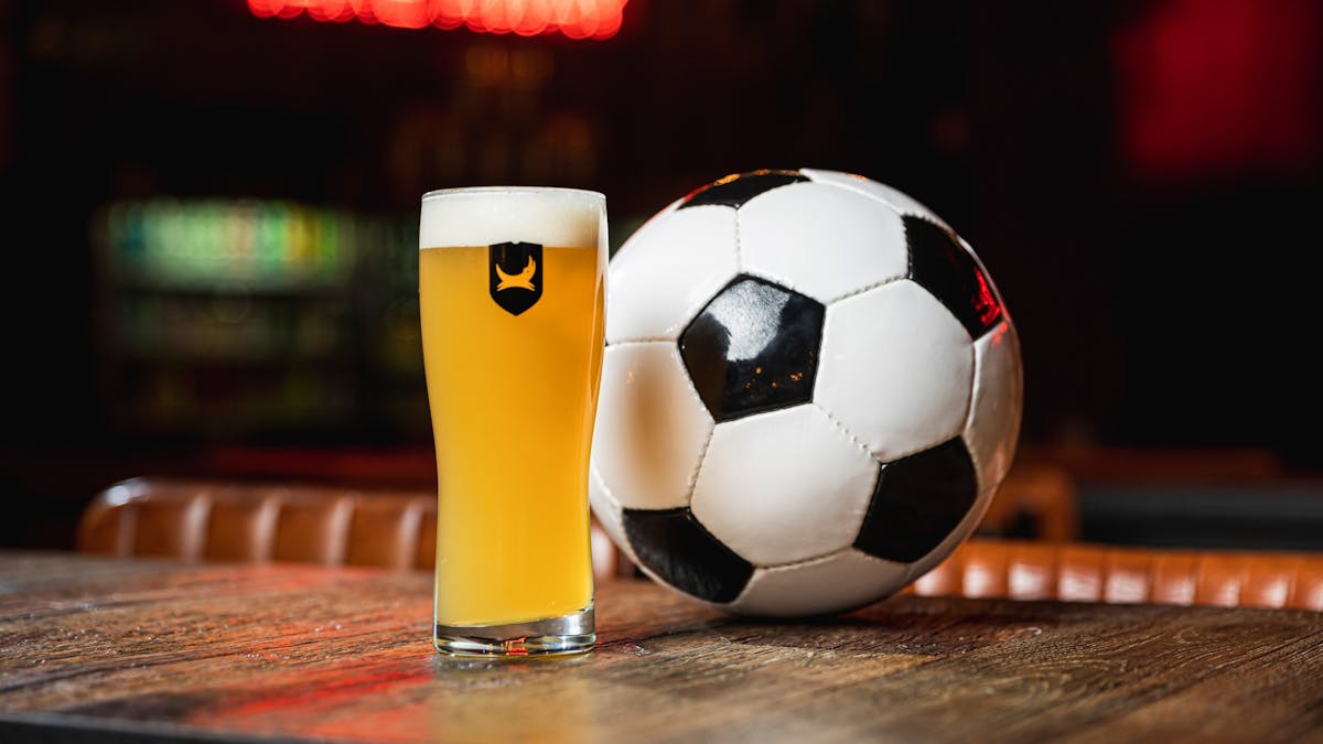 Beer and football on a bench