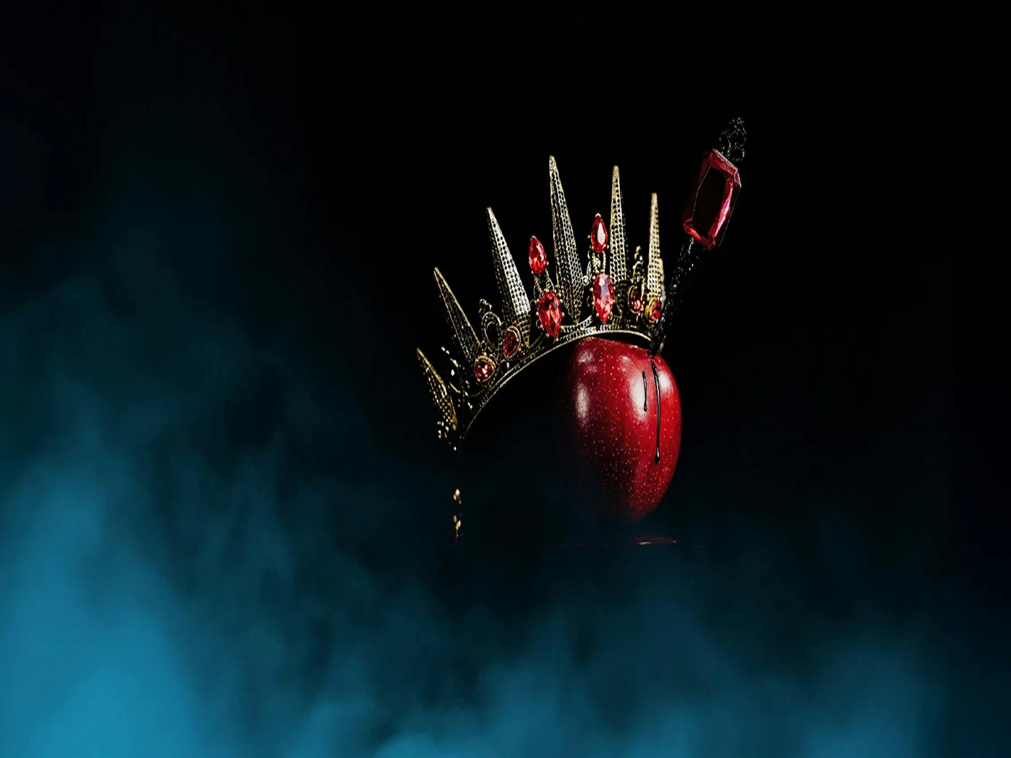 A red apple with a crown and dagger in it. Ballet Theatre Queensland Snow White. A red apple with a crown and dagger in it. Ballet Theatre Queensland Snow White.