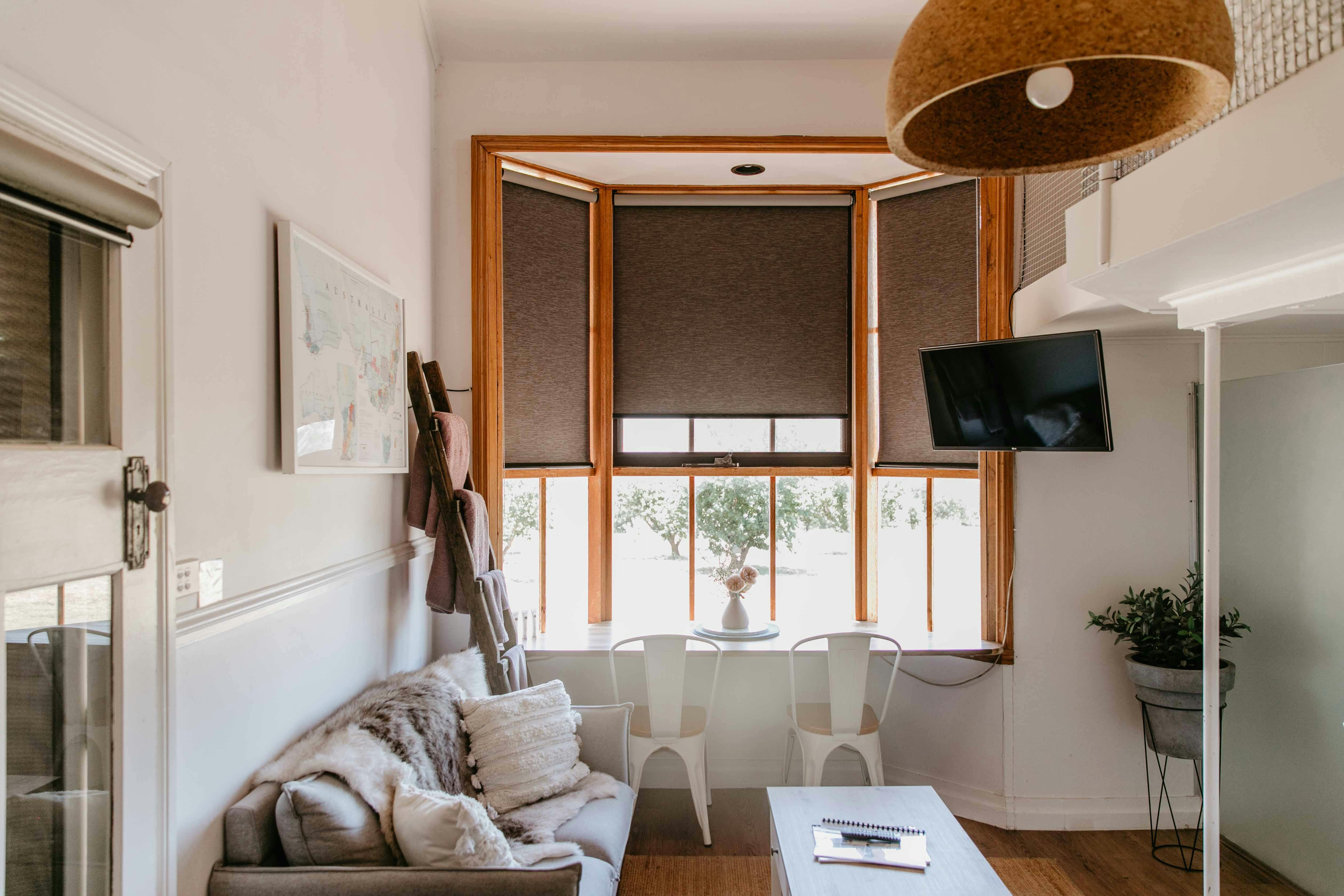 A light-filled room with soft furnishings and large window