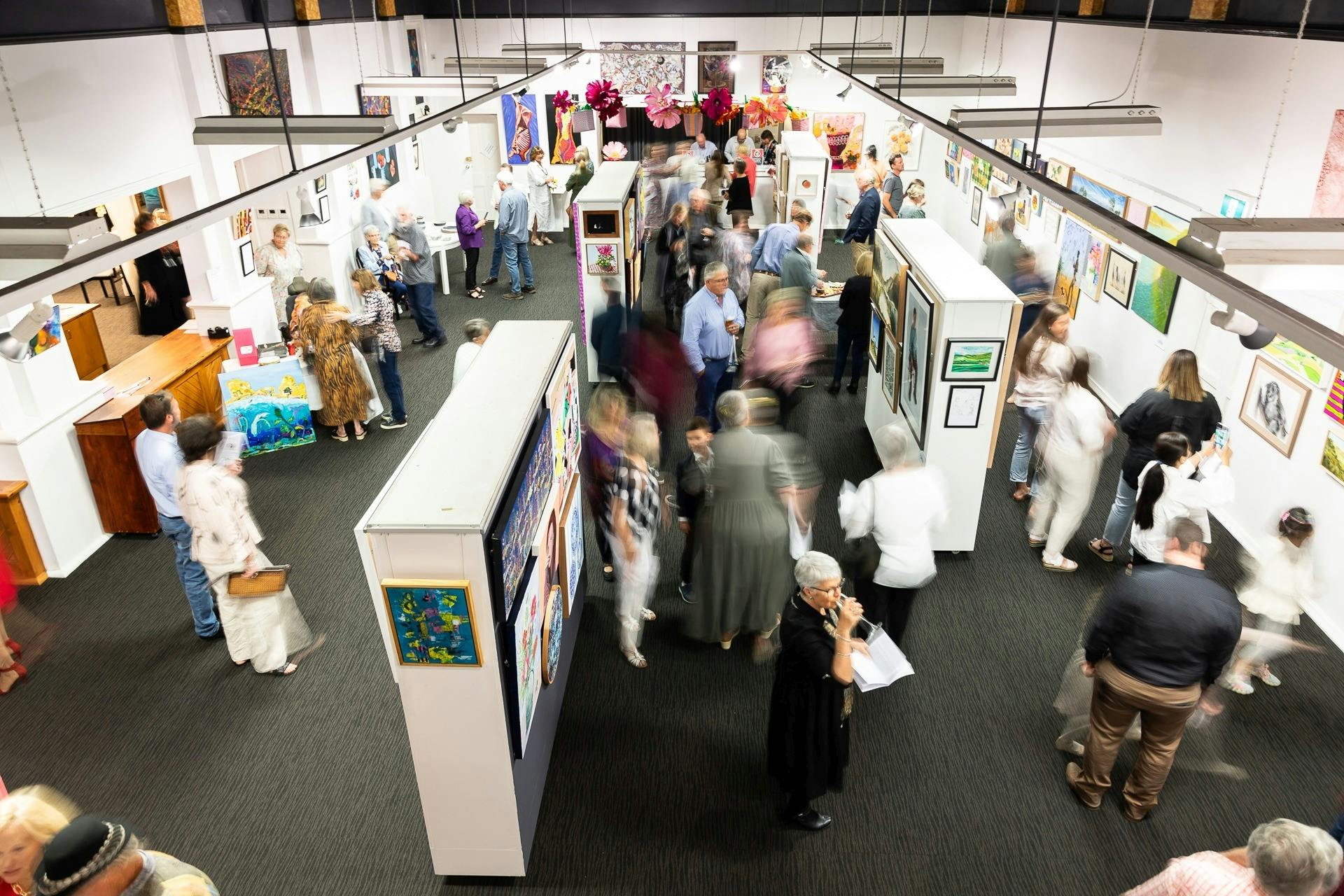 One of the display areas inside the gallery from above with people viewing the display