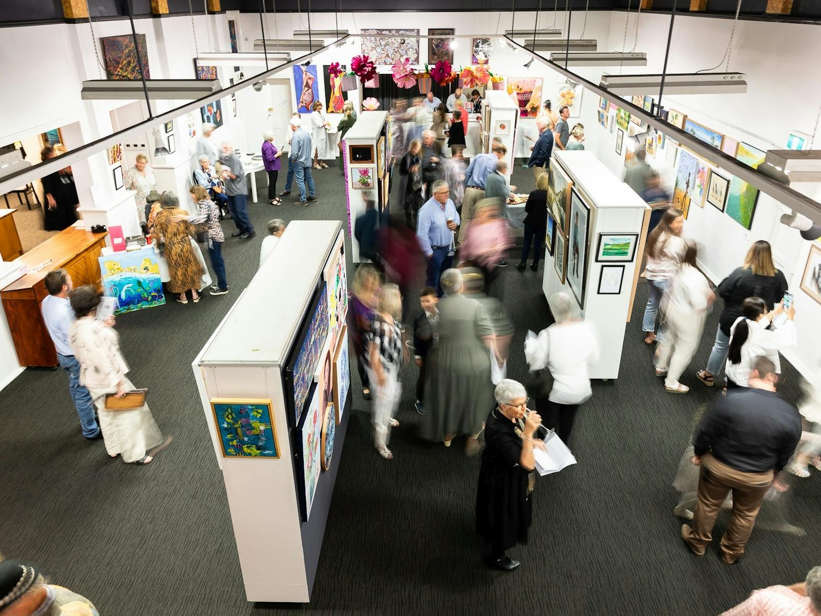 One of the display areas inside the gallery from above with people viewing the display
