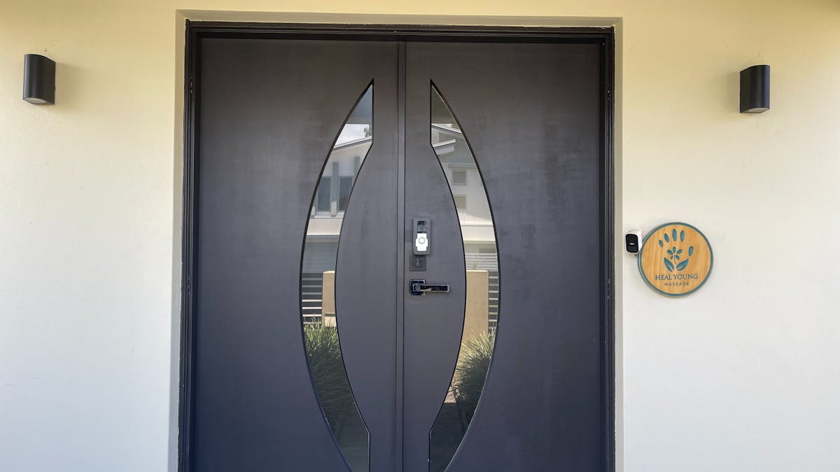 Heal Young Massage clinic entrance with timber logo sign, Varsity Lakes