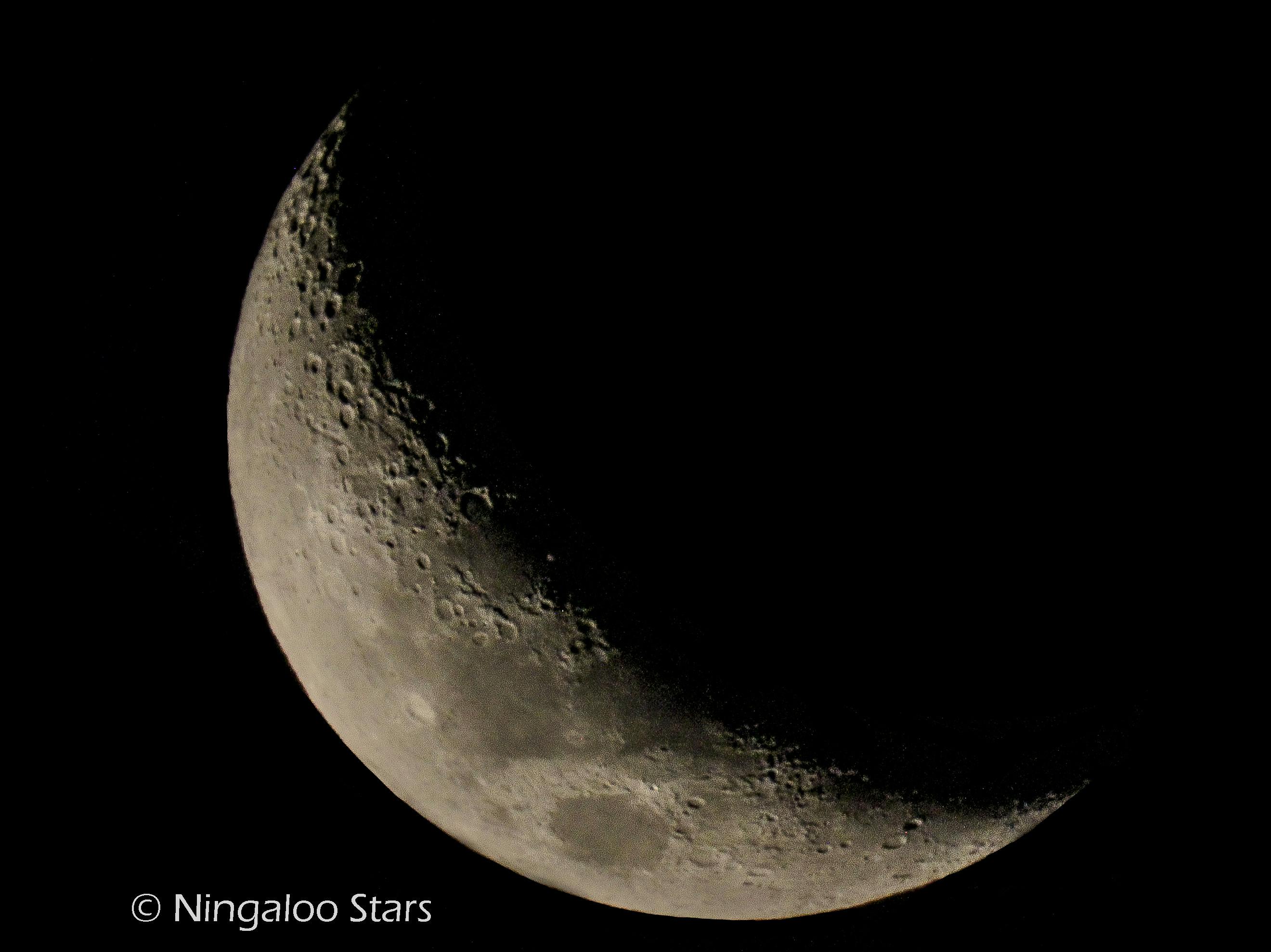 Detailed view of the crescent Moon photographed through a Ningaloo Stars telescope.